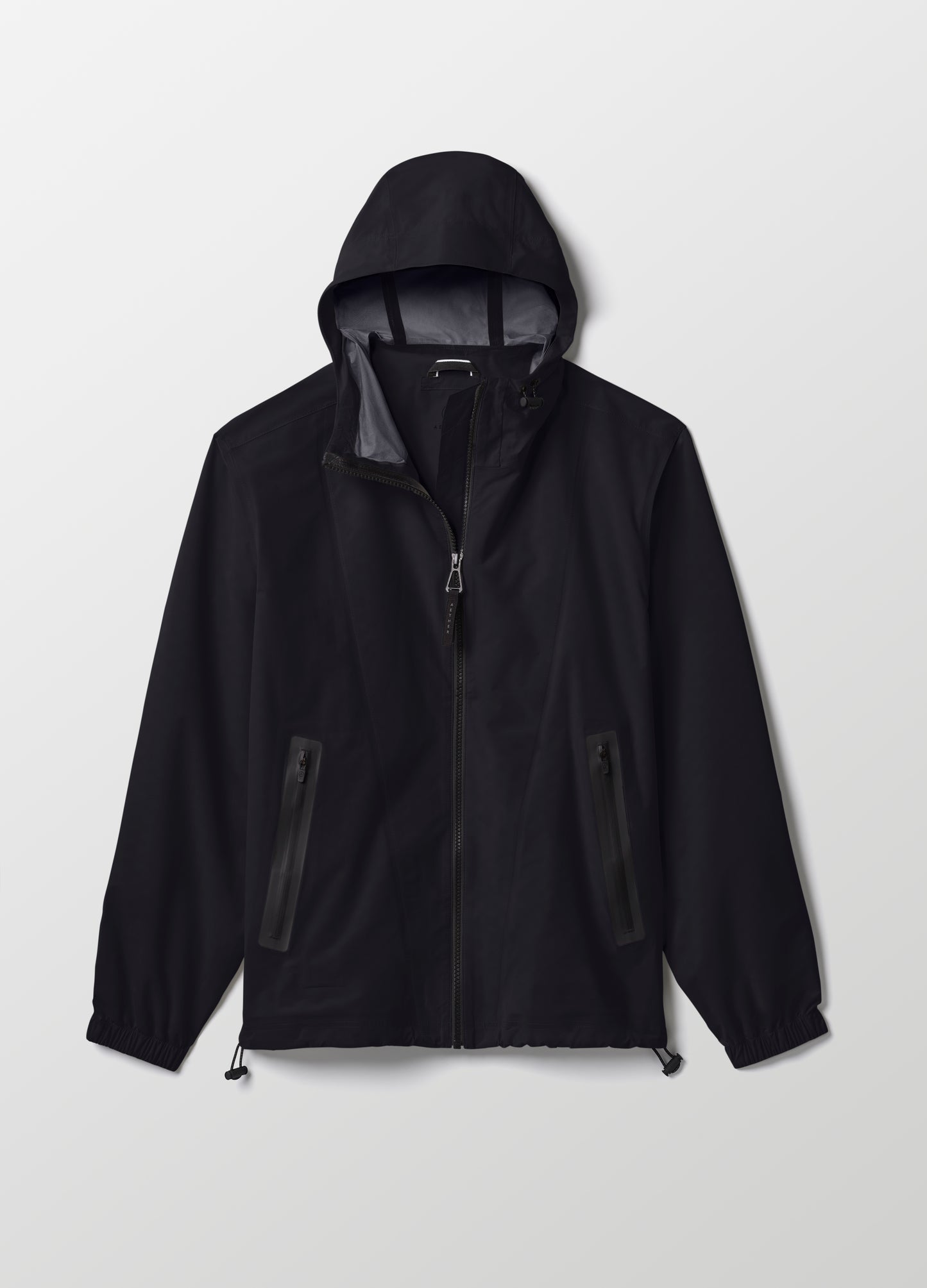 Flat lay of women’s Kite Lightweight Jacket in Onyx Black from AETHER Apparel.