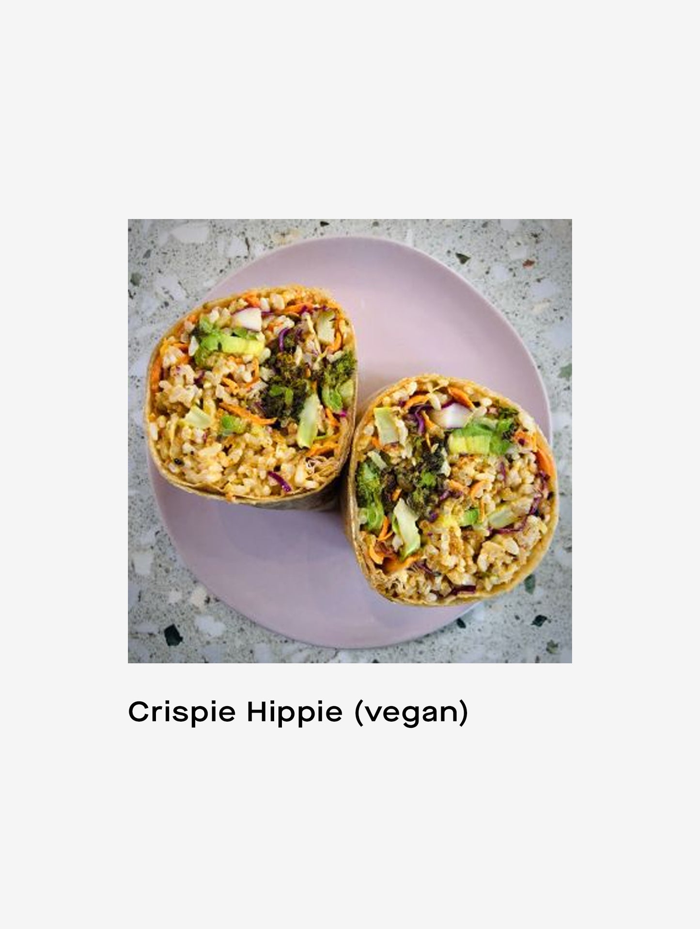 Closeup image of Crispie Hippie vegan wrap on a plate.