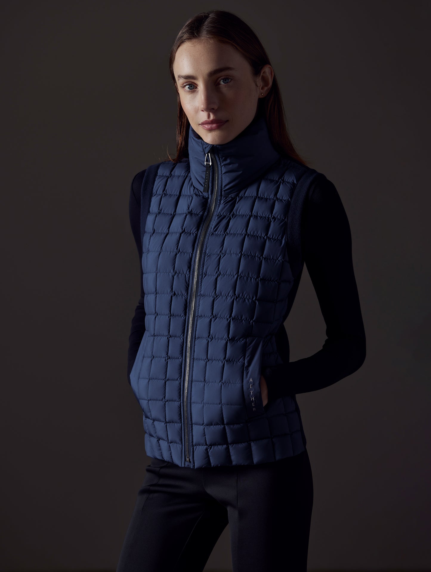 woman wearing blue insulated vest from AETHER Apparel