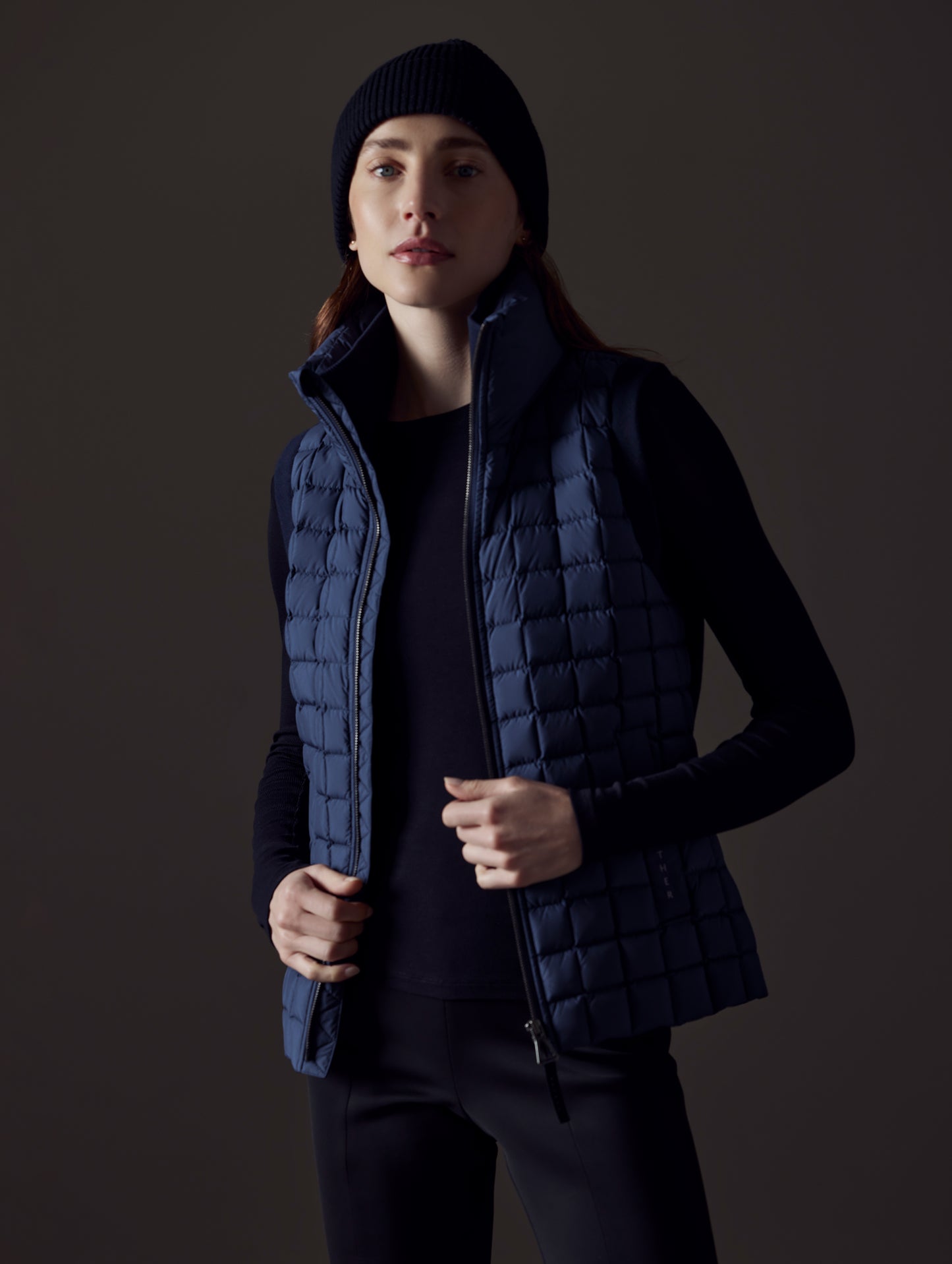 woman wearing blue insulated vest from AETHER Apparel