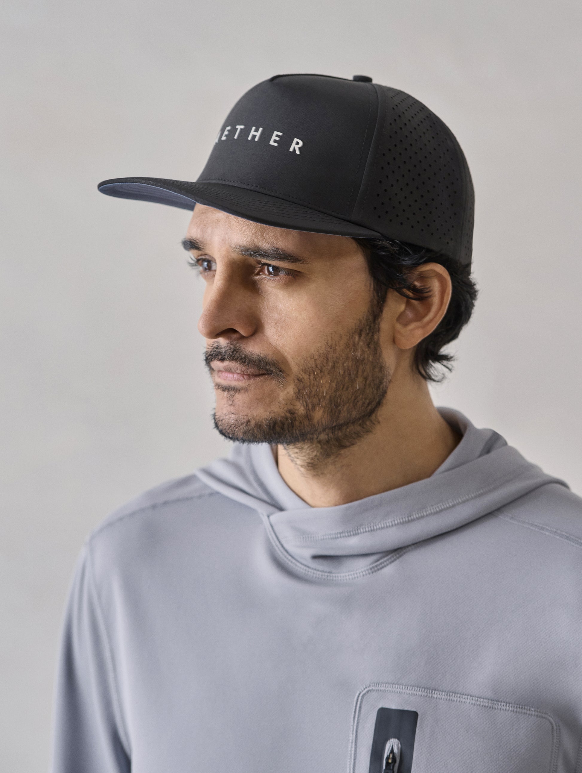 Front 3/4 view of man wearing Adventure Mesh Hat in Onyx Black from AETHER Apparel.