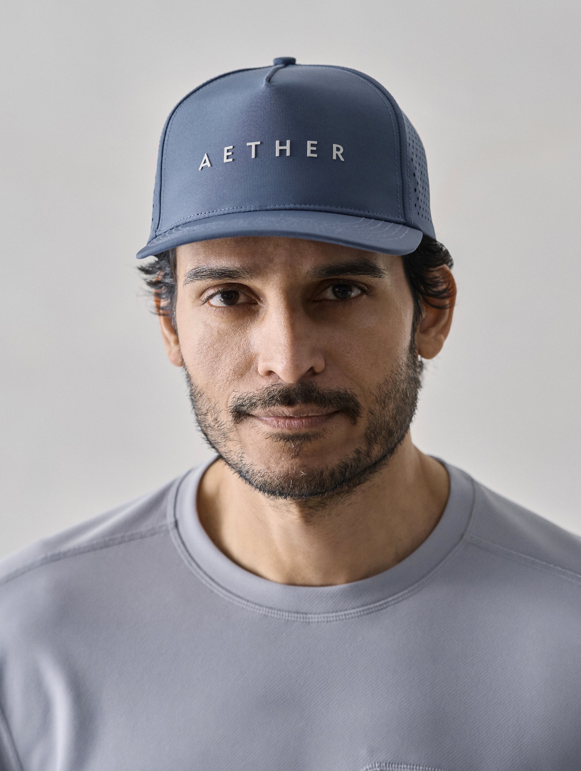 Front view of man wearing Adventure Mesh Hat in Portal Blue from AETHER Apparel.