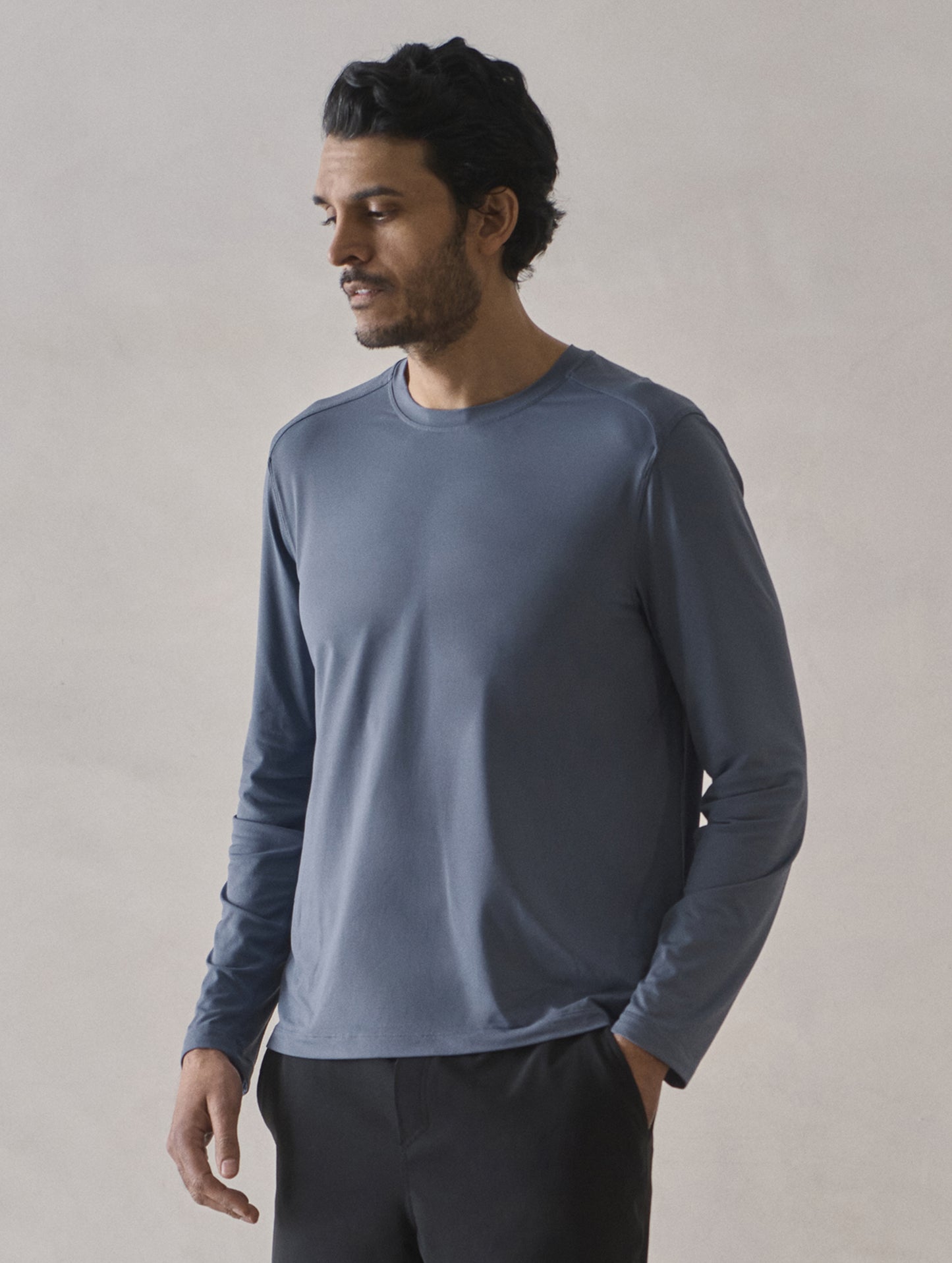 Front 3/4 upper-body view of man wearing Adventure Performance Long-Sleeve Tee in Portal Blue from AETHER Apparel.