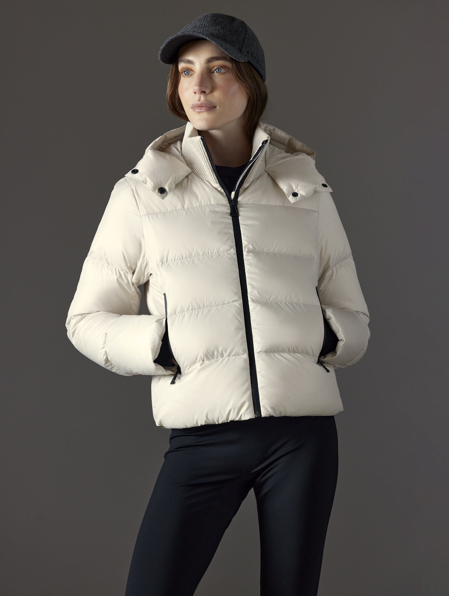 Front body view of woman wearing Aura Puffer Jacket in Bone white from AETHER Apparel.
