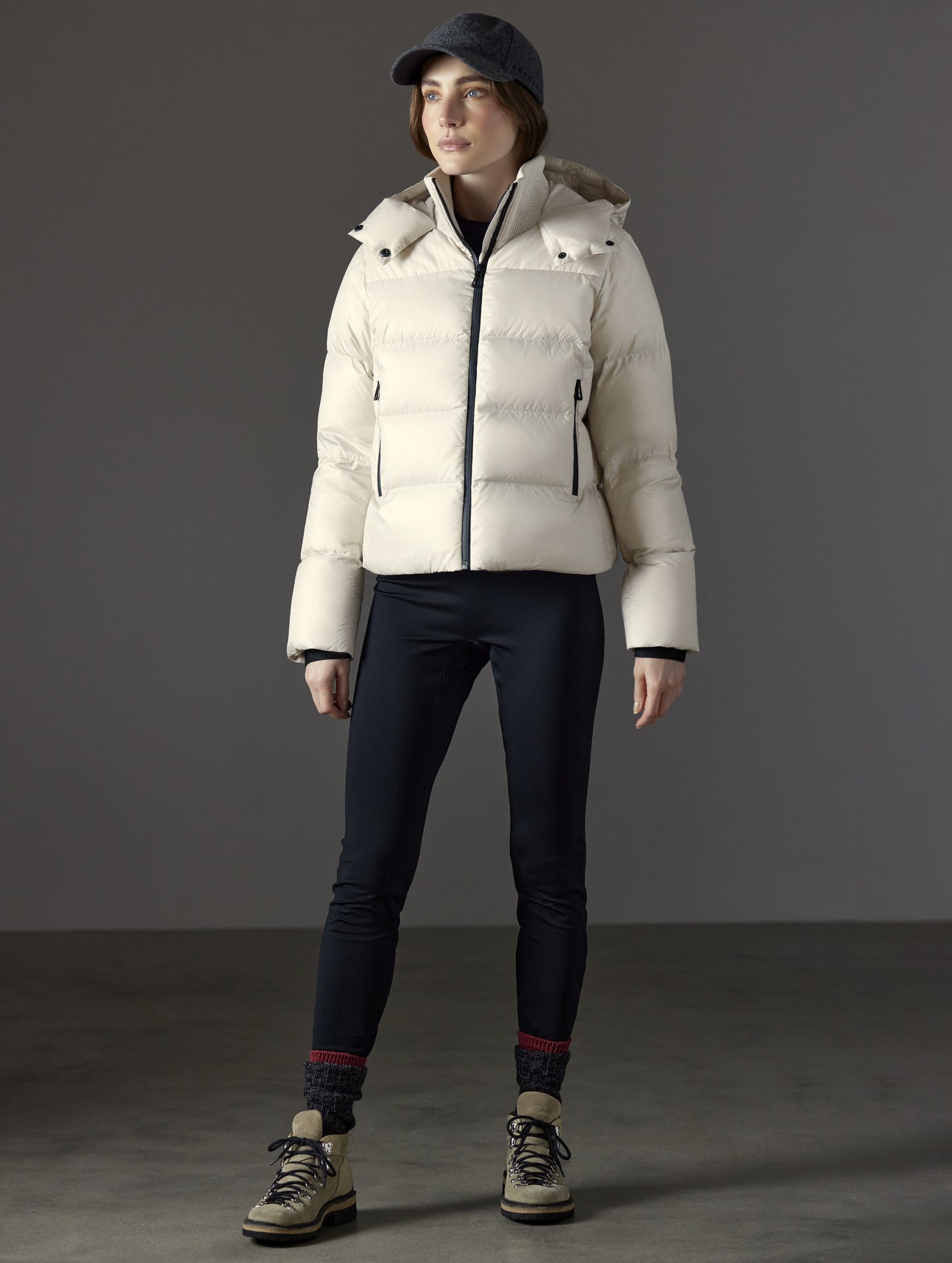 Front full-body view of woman wearing Aura Puffer Jacket in Bone white from AETHER Apparel.