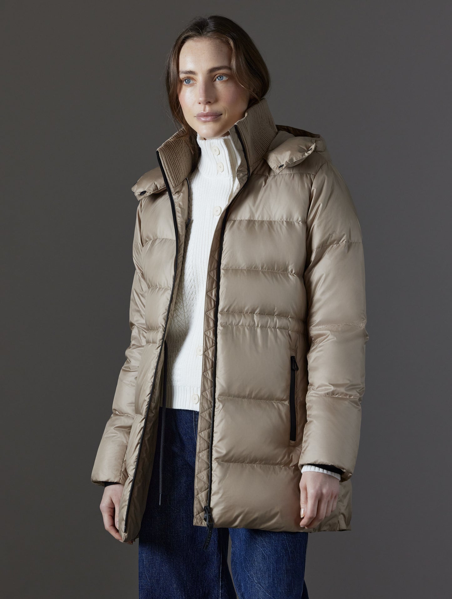 Front angled view of woman wearing unzipped Aura Puffer Long in Chinchilla Brown from AETHER Apparel.