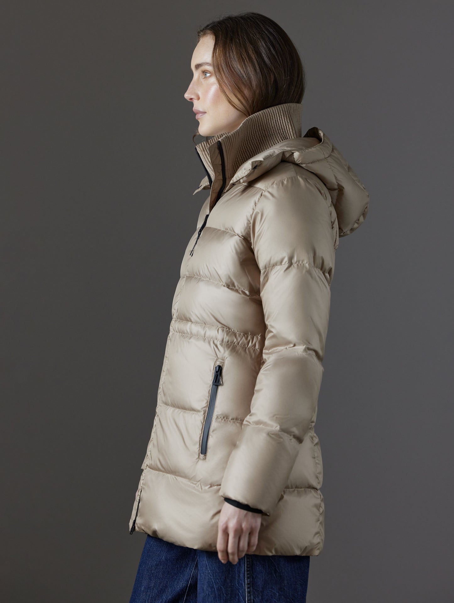 Side profile view of woman wearing Aura Puffer Long in Chinchilla Brown from AETHER Apparel.