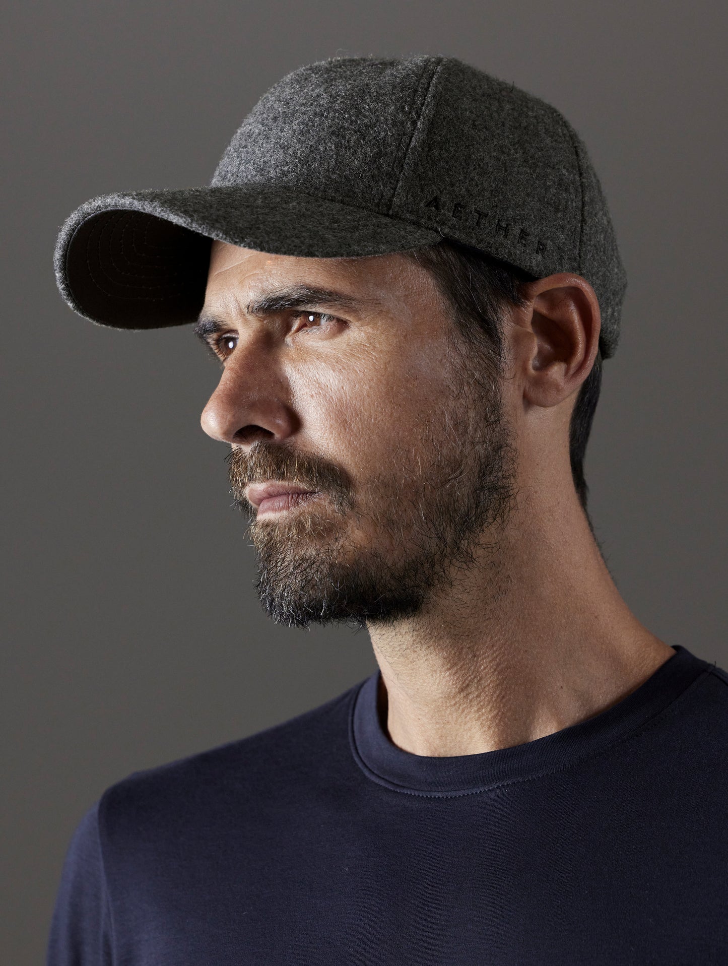 Front angled view of man wearing AETHER Wool Hat in Charcoal Heather from AETHER Apparel.