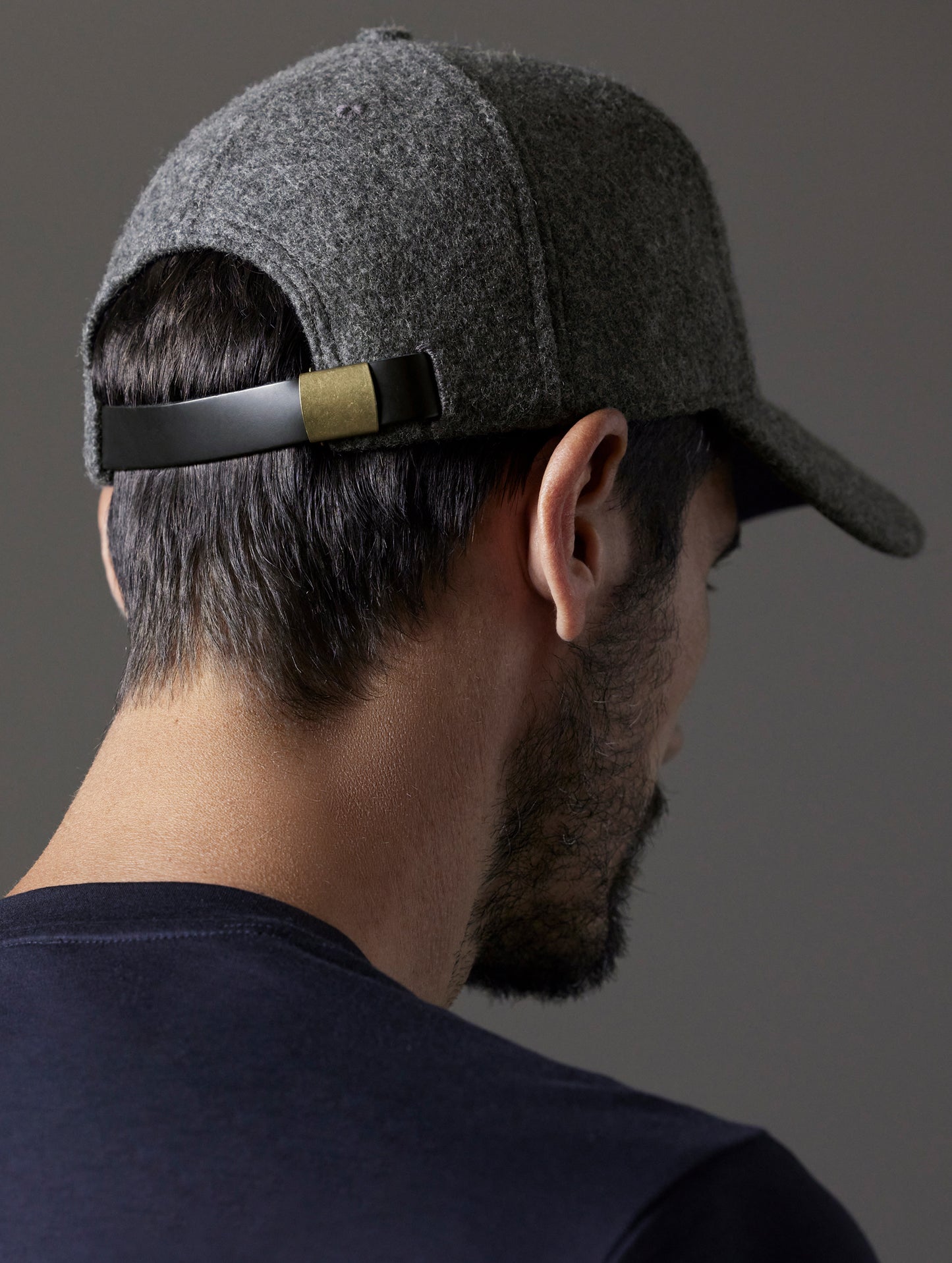 Rear angled view of man wearing AETHER Wool Hat in Charcoal Heather from AETHER Apparel.