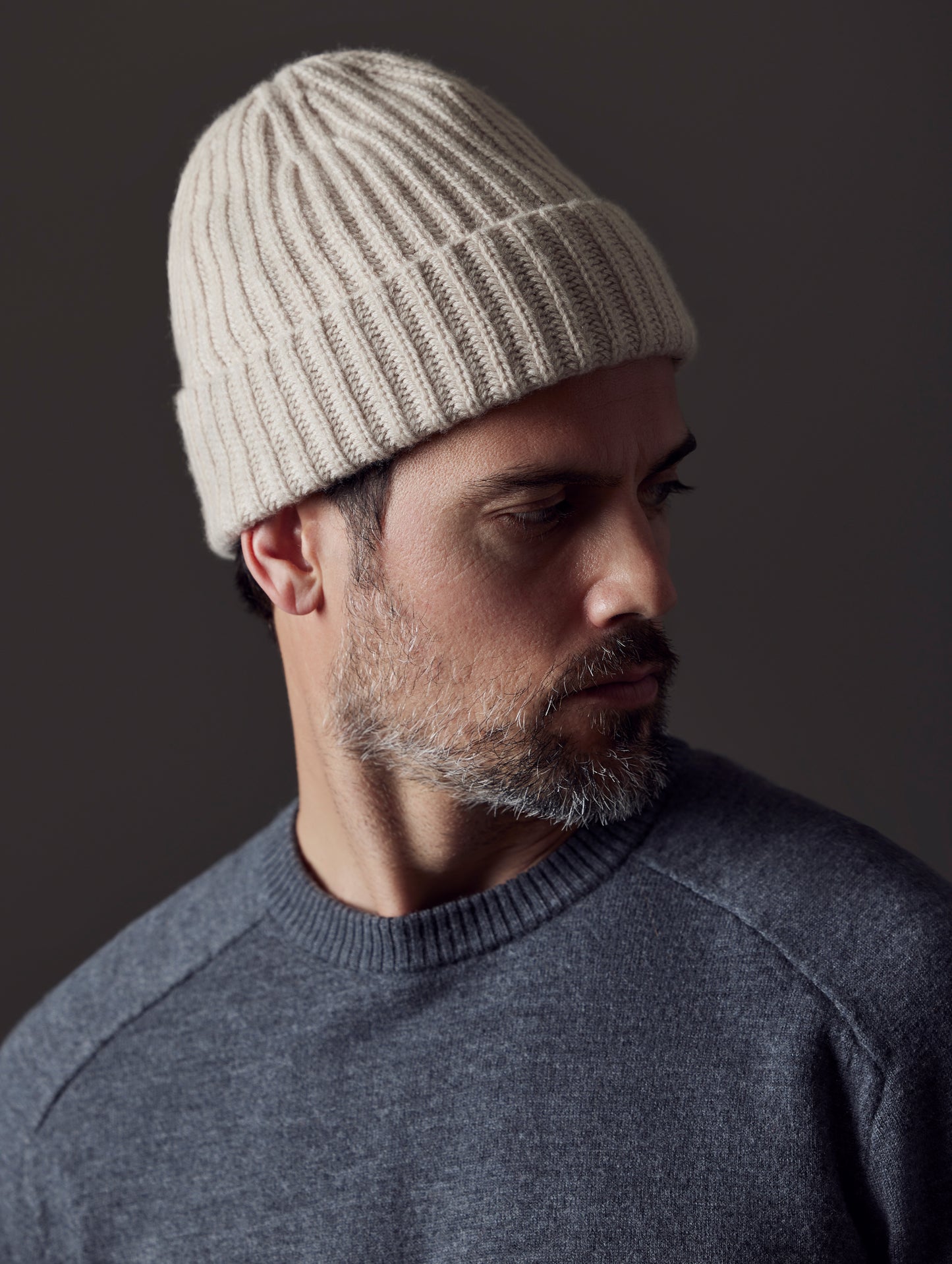 Front angled closeup shoulder and head view of man wearing Cashmere Hat in Oatmeal Heather from AETHER Apparel.