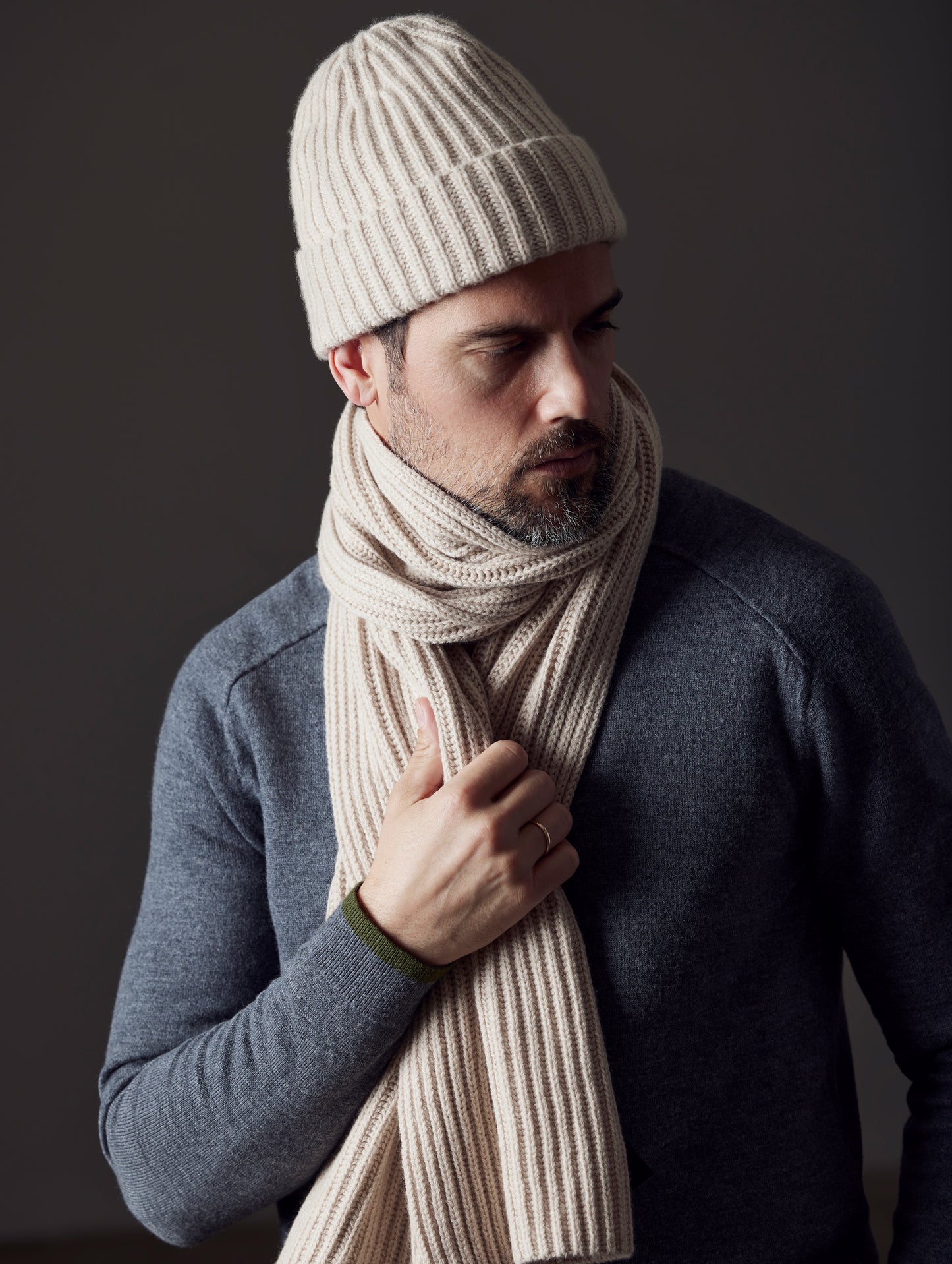 Front angled upper body view of man wearing scarf and Cashmere Hat in Oatmeal Heather from AETHER Apparel.