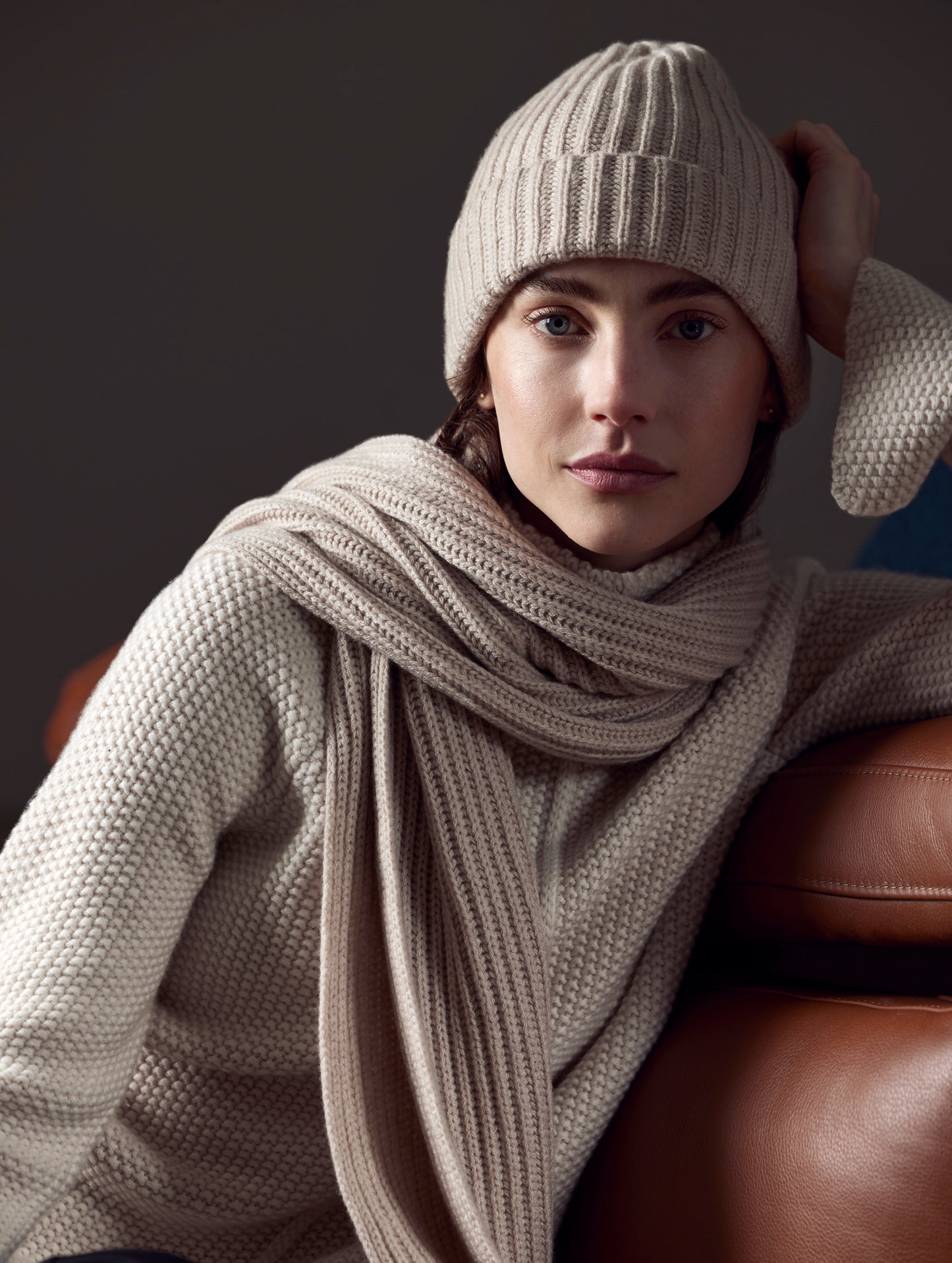 Front view of woman wearing scarf and Cashmere Hat in Oatmeal Heather from AETHER Apparel.