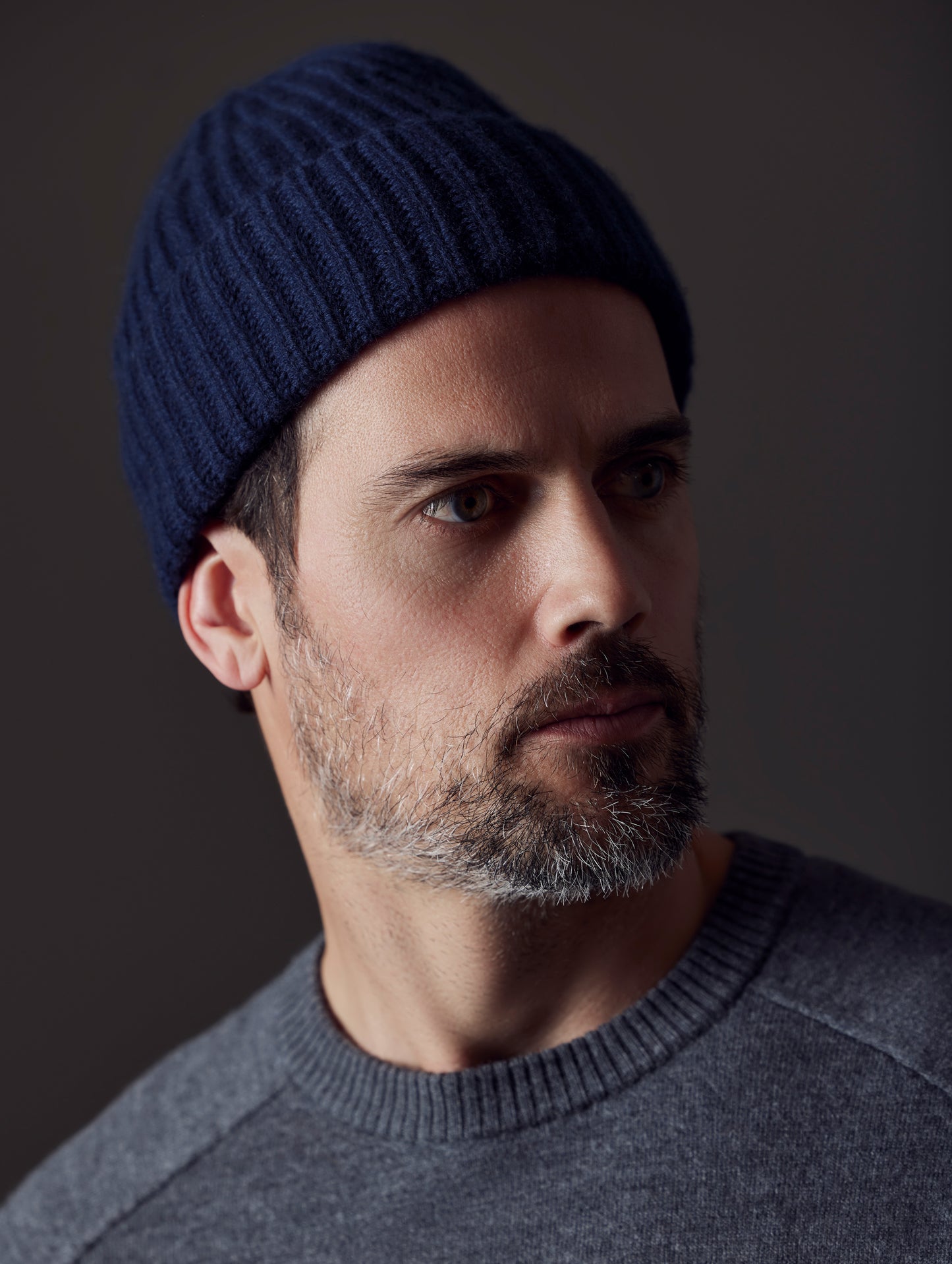 Front angled view of man wearing Cashmere Hat in Total Eclipse Dark Blue from AETHER Apparel.