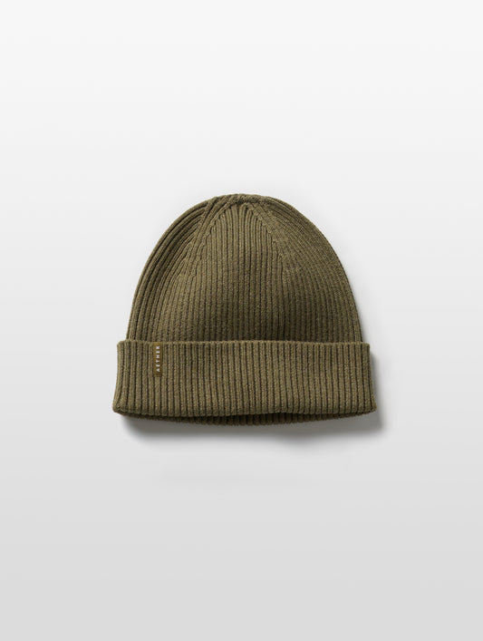 Flat lay of Chalet Cotton Beanie in Command Green Heather from AETHER Apparel.