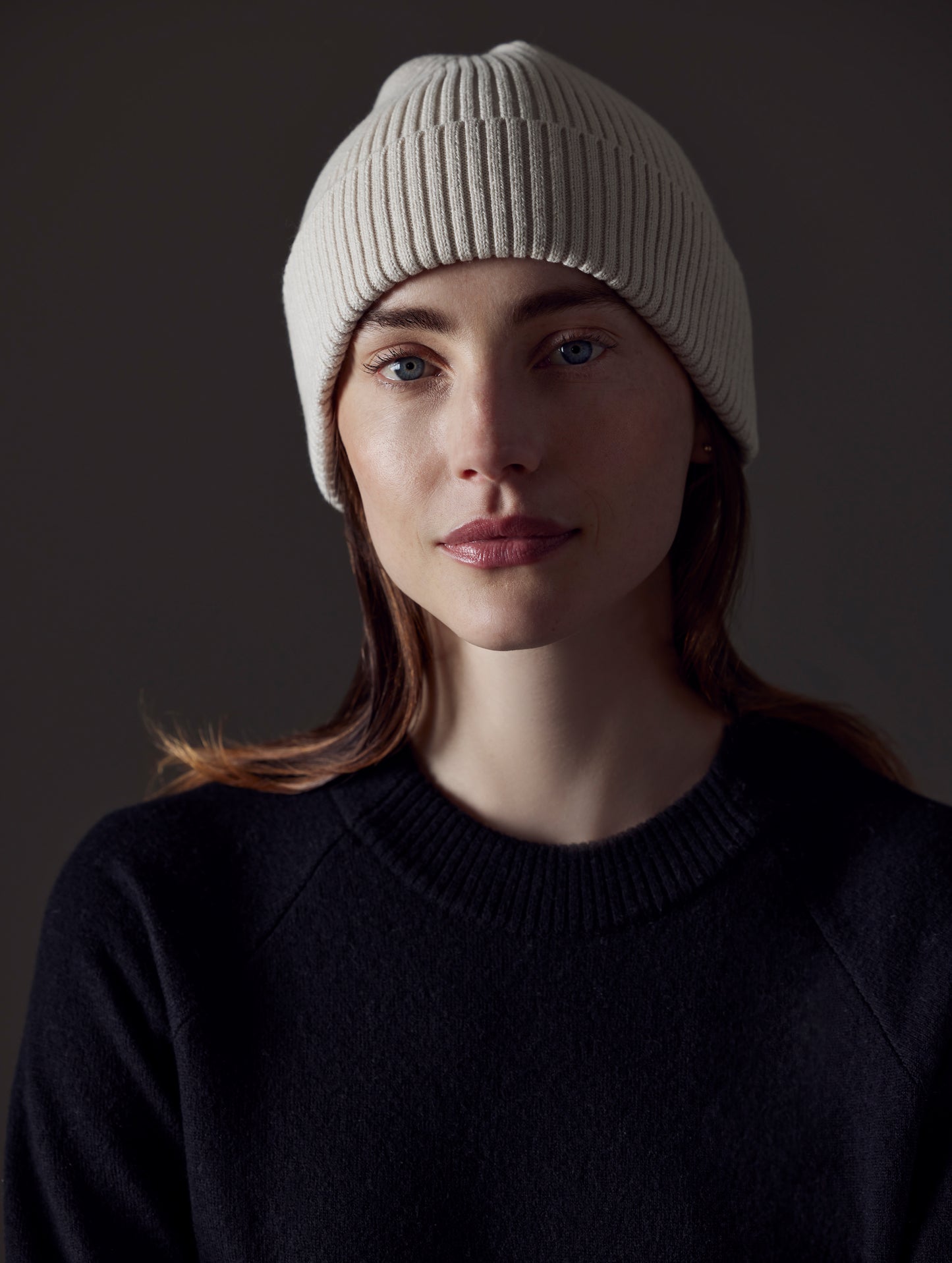 Front view of woman wearing Chalet Cotton Beanie in Winter White Heather from AETHER Apparel.