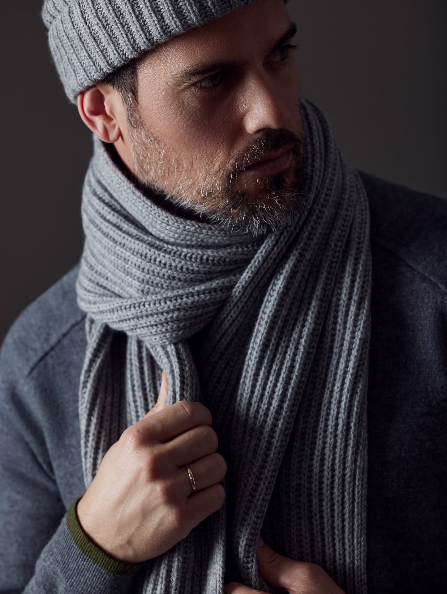 Front angled view of man wearing Ribbed Cashmere Scarf in Heather Grey from AETHER Apparel.