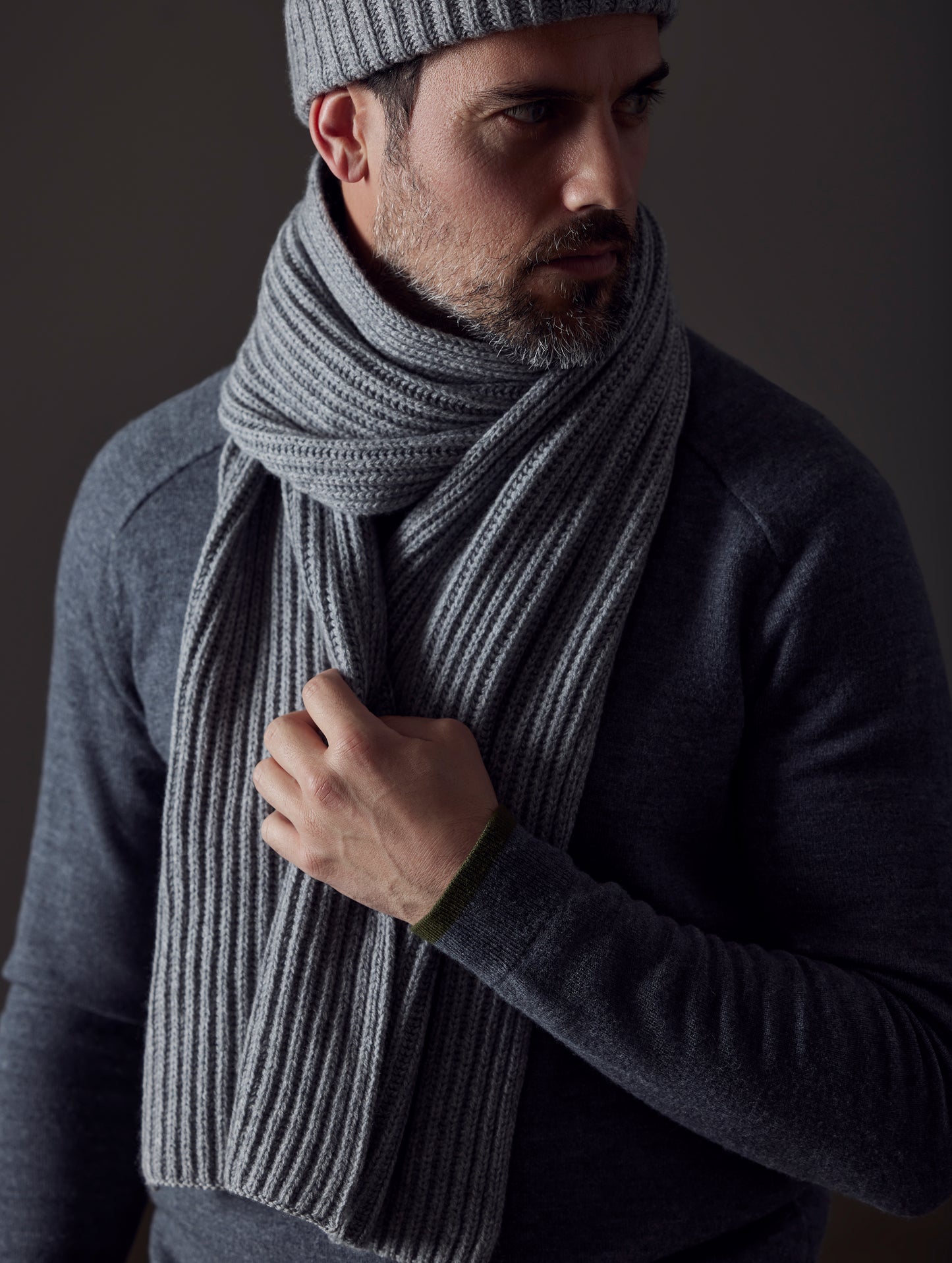 Front view of man wearing Ribbed Cashmere Scarf in Heather Grey from AETHER Apparel.