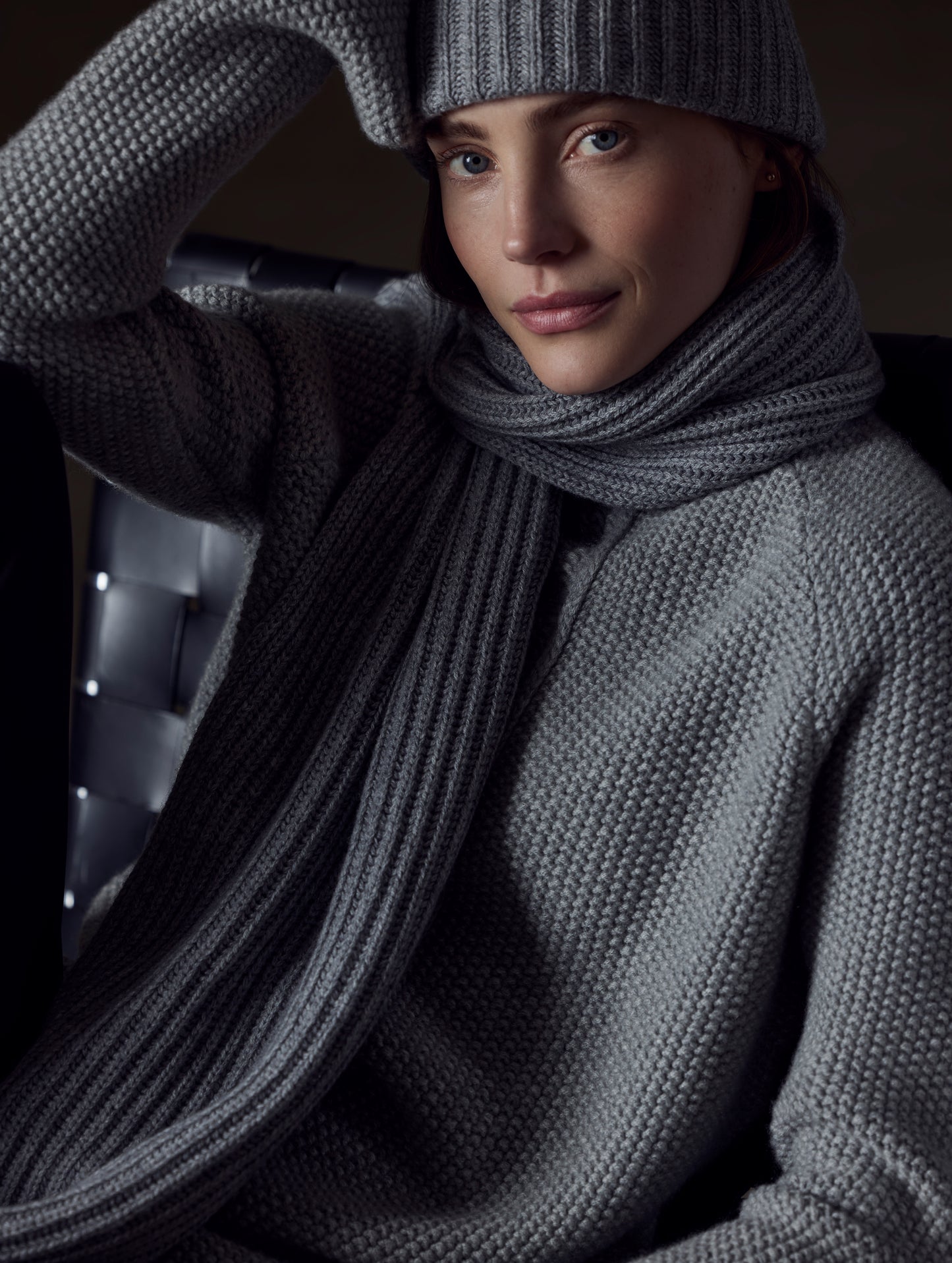 Front view of woman wearing beanie and Ribbed Cashmere Scarf in Heather Grey from AETHER Apparel.