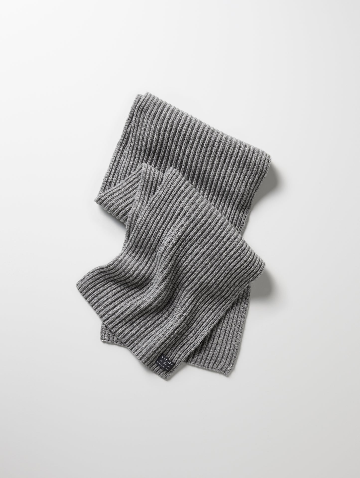 Flat lay of Ribbed Cashmere Scarf in Heather Grey from AETHER Apparel.