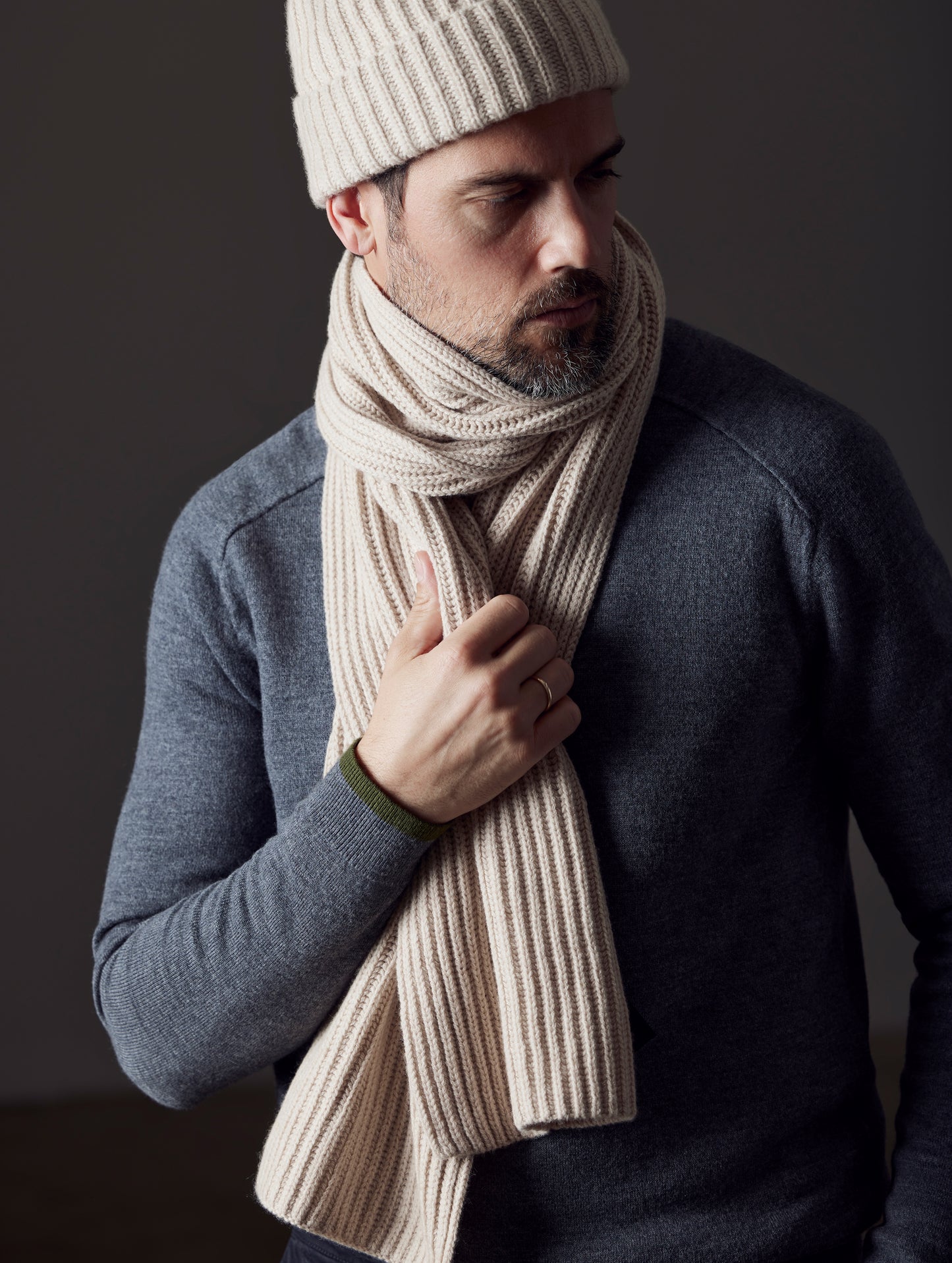 Front view of man wearing Ribbed Cashmere Scarf in Oatmeal Heather from AETHER Apparel.