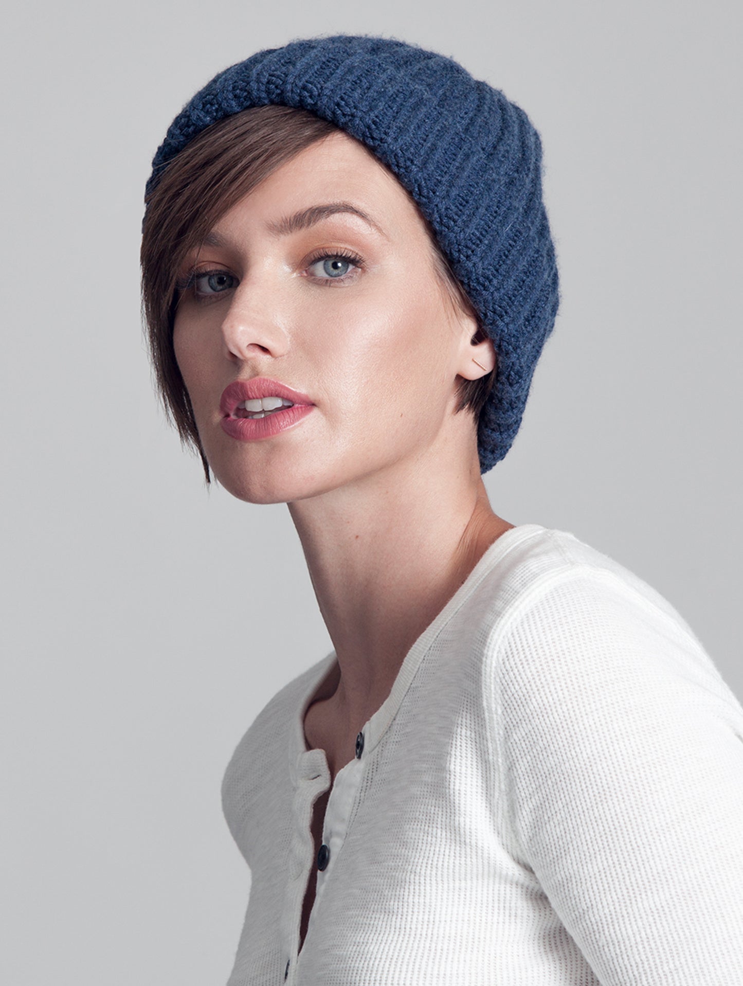 Front view of woman wearing blue Seasons Hat from AETHER Apparel.
