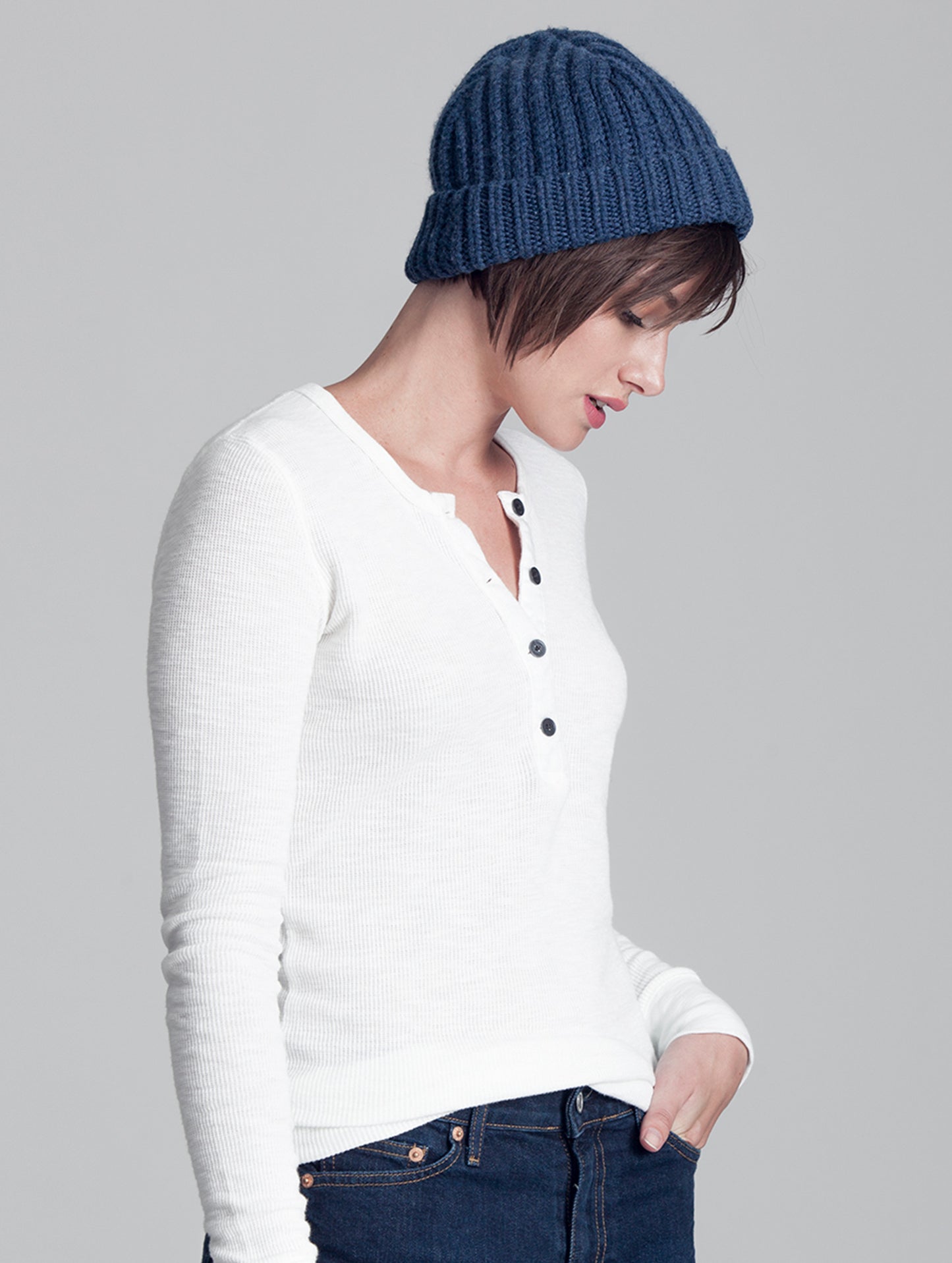 Right side angled view of woman wearing blue Seasons Hat from AETHER Apparel.