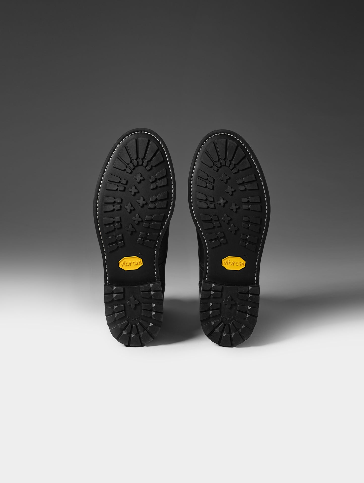 View of the Vibram outsoles on the bottom of the Tioga Moto Boot in Onyx Black from AETHER Apparel.