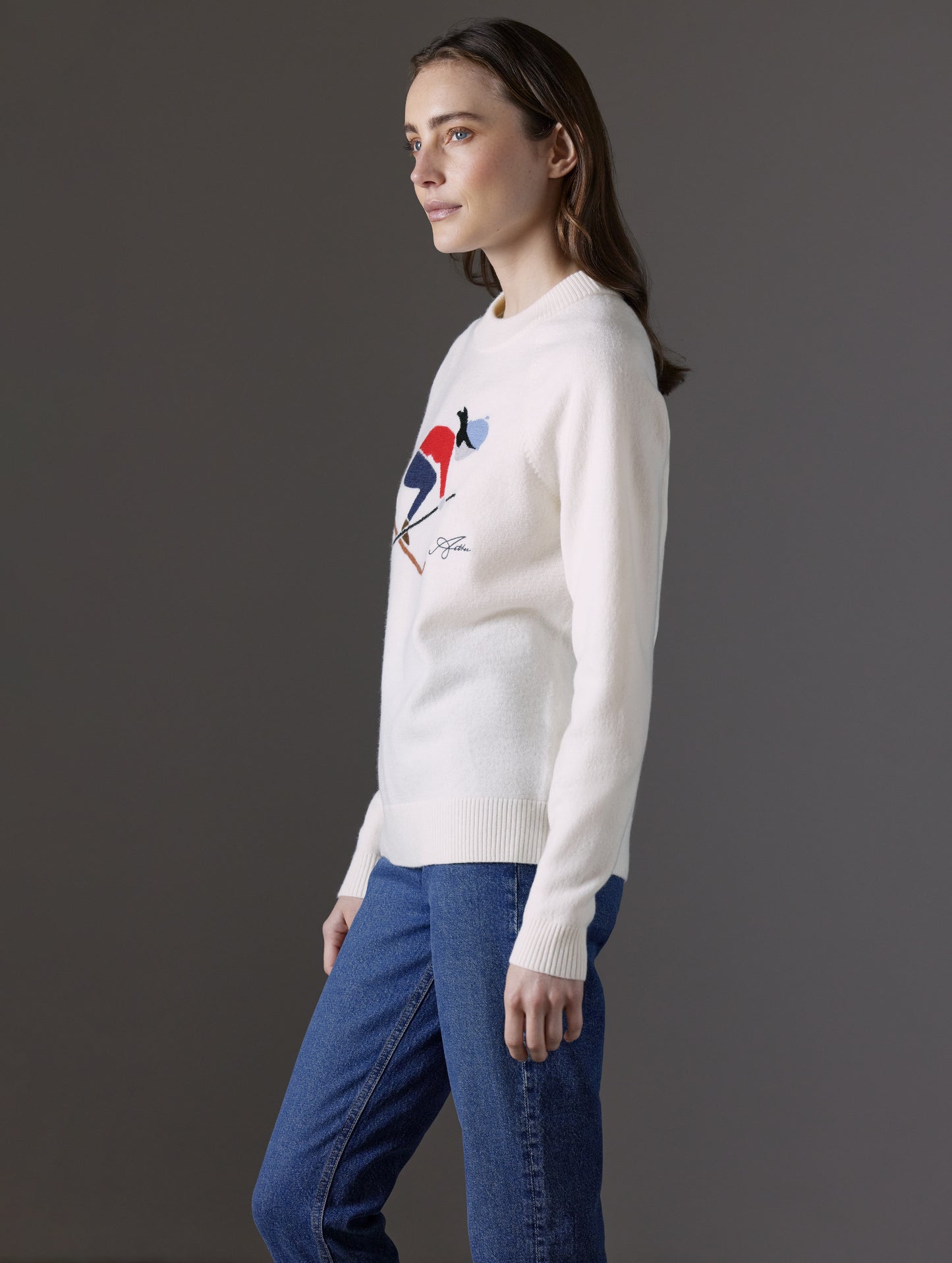 Side profile view of woman wearing Bridget Sweater in Winter White from AETHER Apparel.
