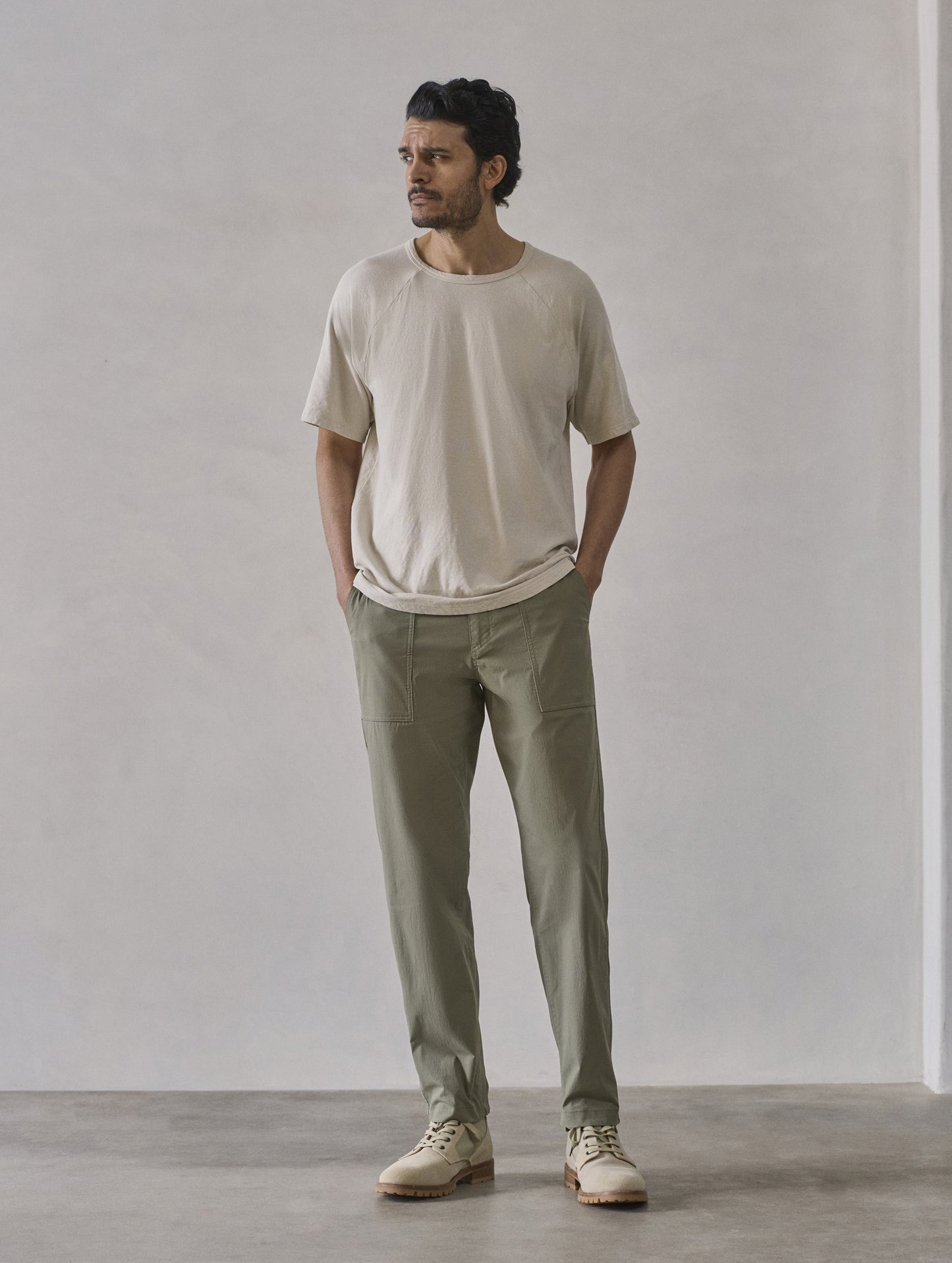 Front full-body view of man wearing Buckhorn Cotton Raglan Tee 2.0 in Bone white from AETHER Apparel.