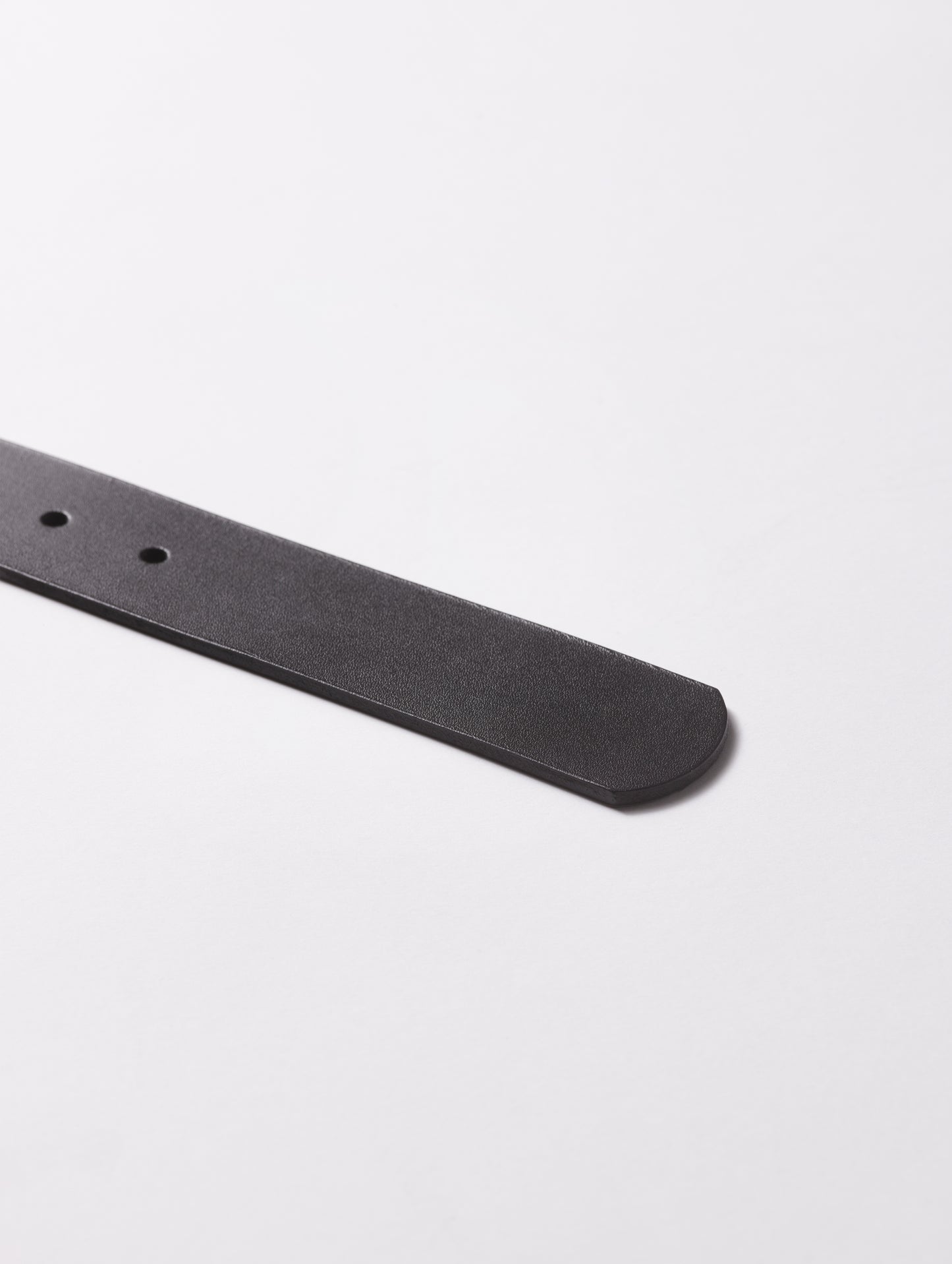End tip of black Canyon Leather Belt from AETHER Apparel.
