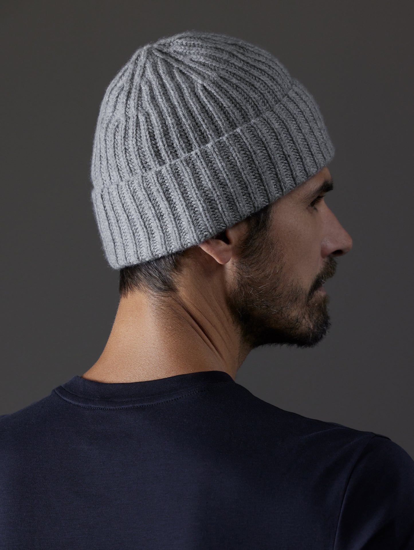 Rear angled view of man wearing Cashmere Hat in Heather Grey from AETHER Apparel.