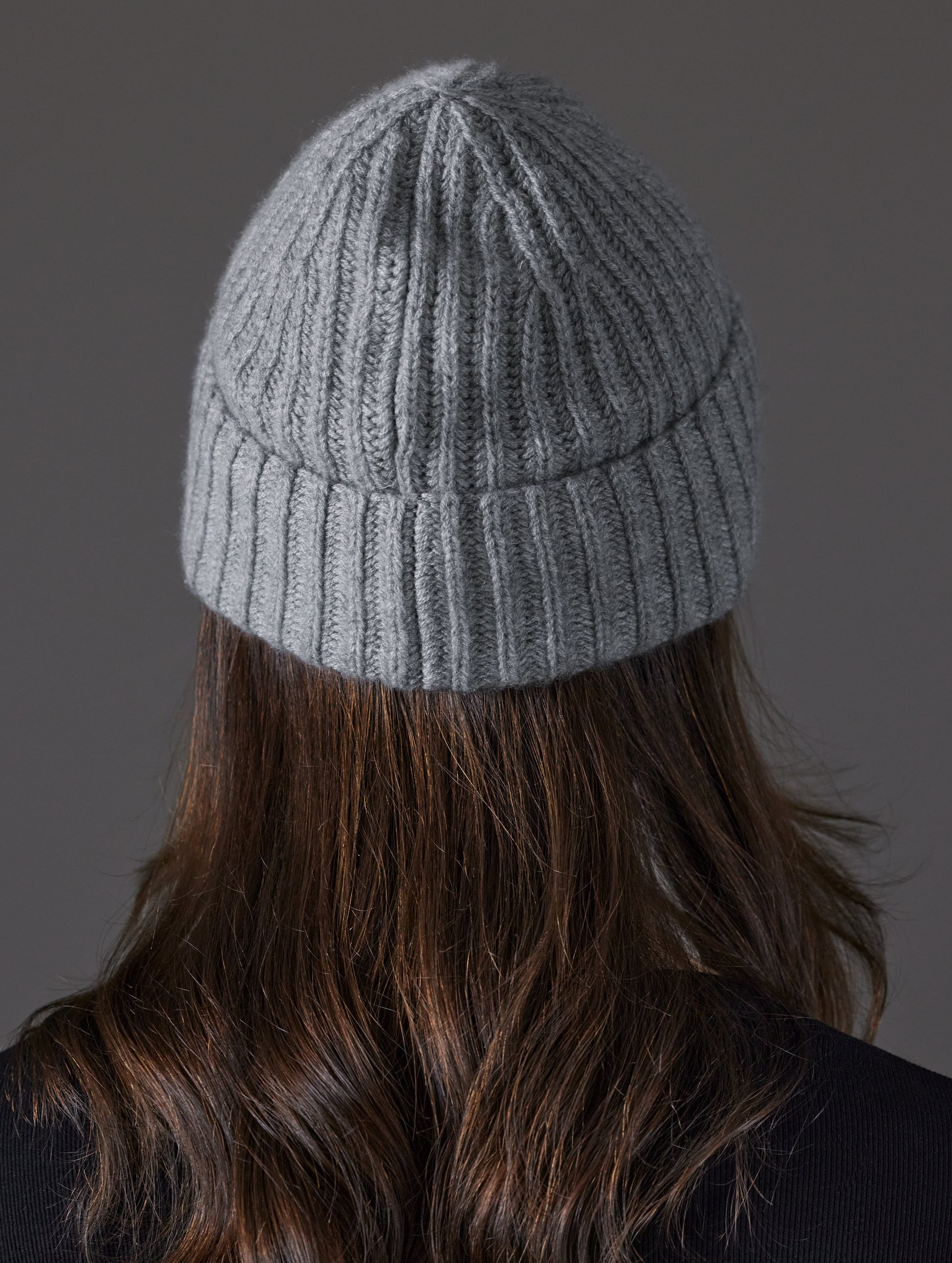 Rear view of woman wearing Cashmere Hat in Heather Grey from AETHER Apparel.