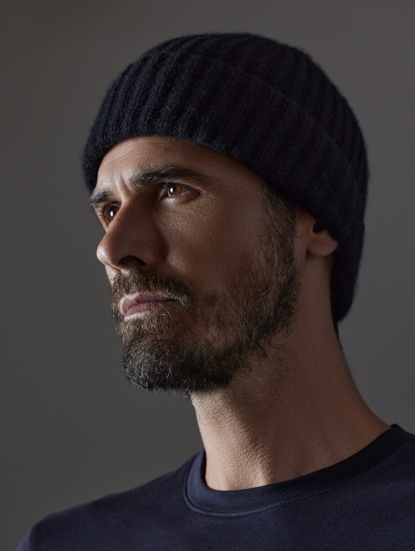 Front angled view of man wearing Cashmere Hat in Onyx Black from AETHER Apparel.