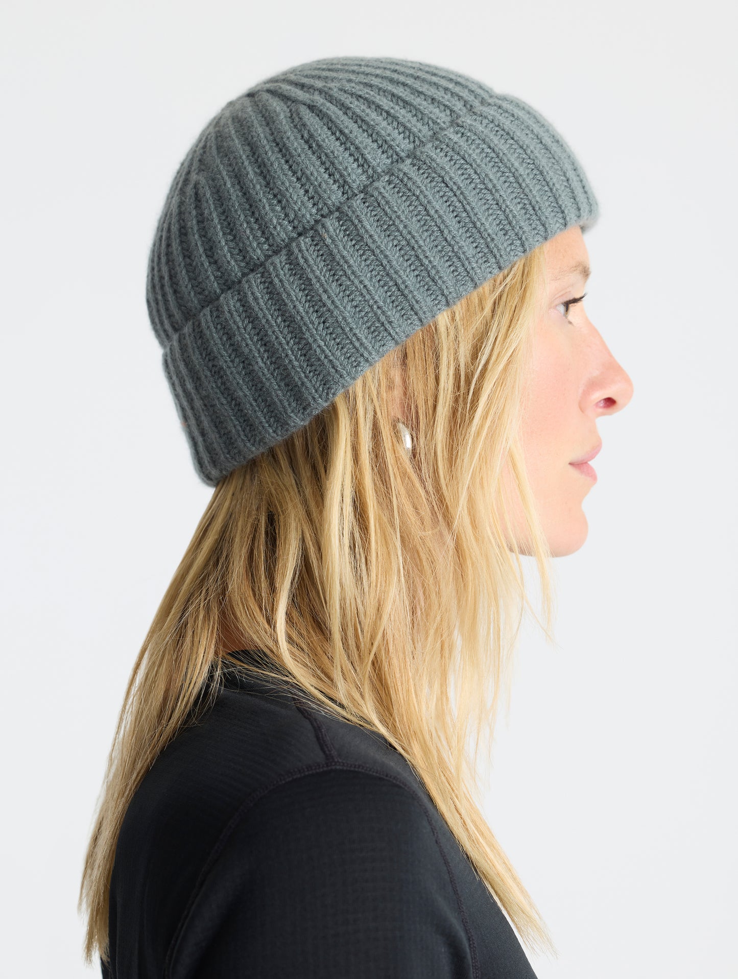 Side profile view of woman wearing the Cashmere Hat in Gunmetal from AETHER Apparel.