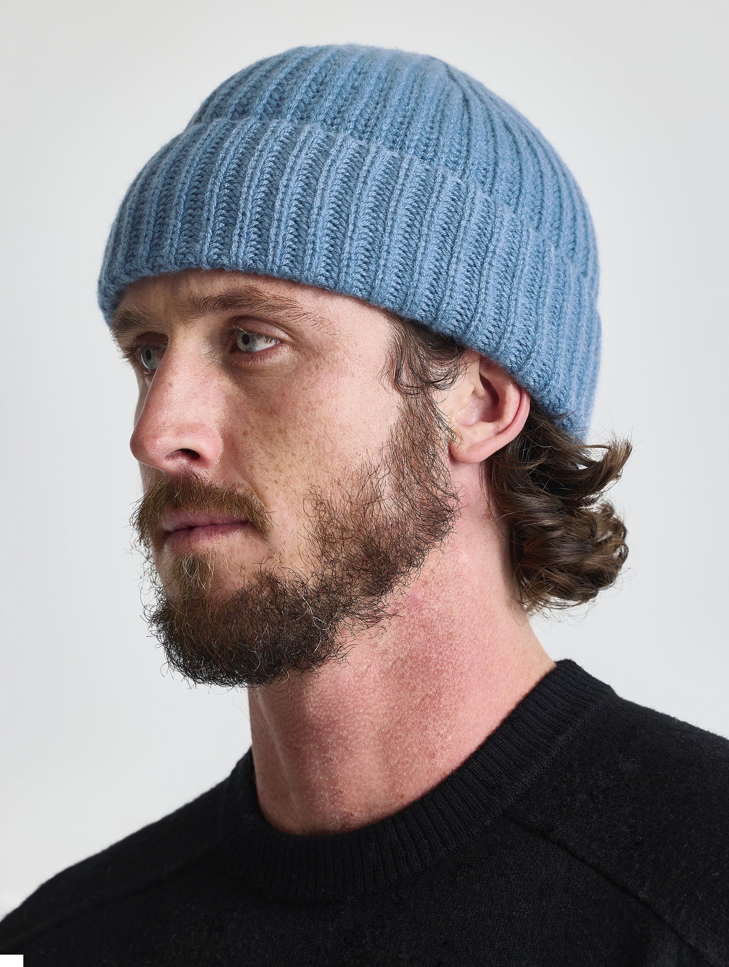 Front angled view of man wearing the Cashmere Hat in Portal Blue from AETHER Apparel.