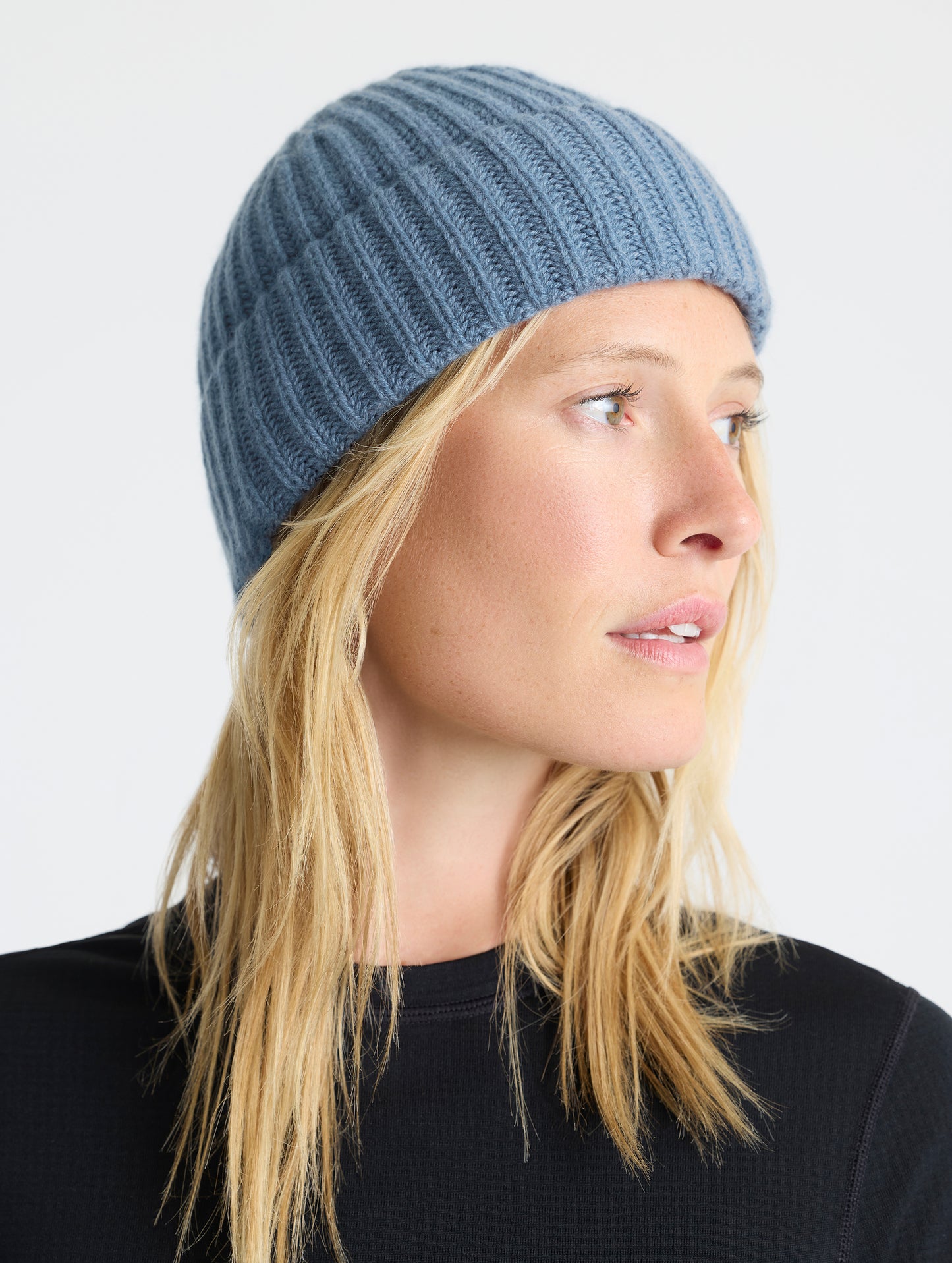 Front angled view of woman wearing the Cashmere Hat in Portal Blue from AETHER Apparel.