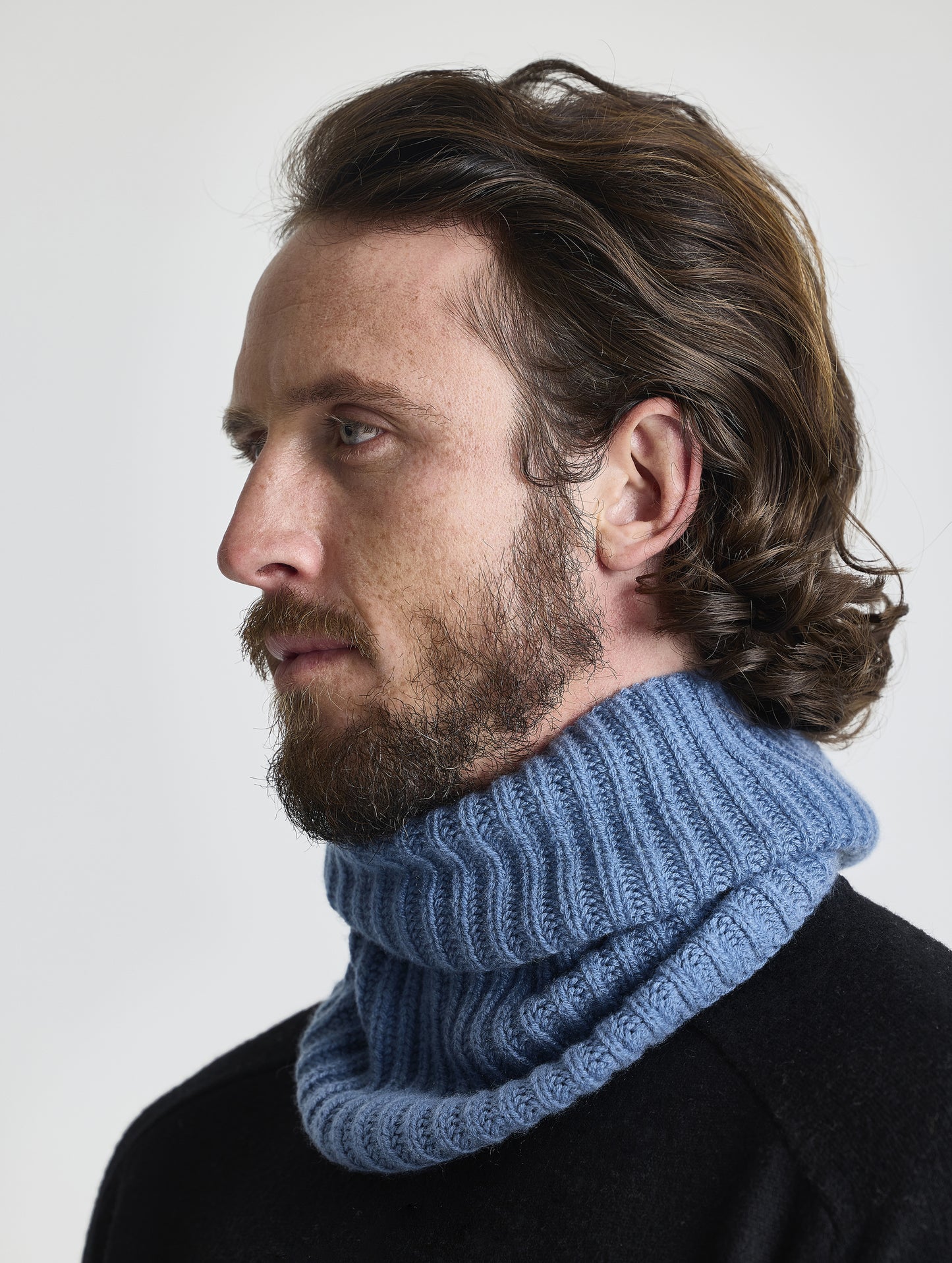 Front angled view of man wearing the Cashmere Neck Gaiter in Portal Blue from AETHER Apparel.