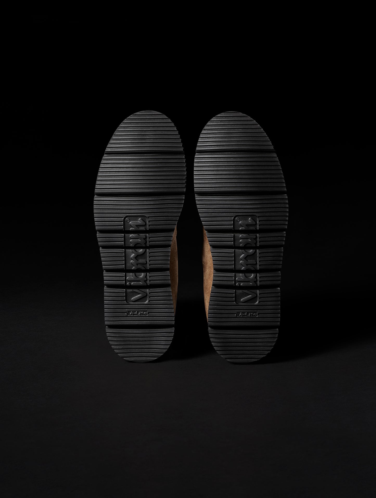 Bottom view of Vibram Vi-Lite outsoles on AETHER Chelsea Boot in Taupe from AETHER Apparel.