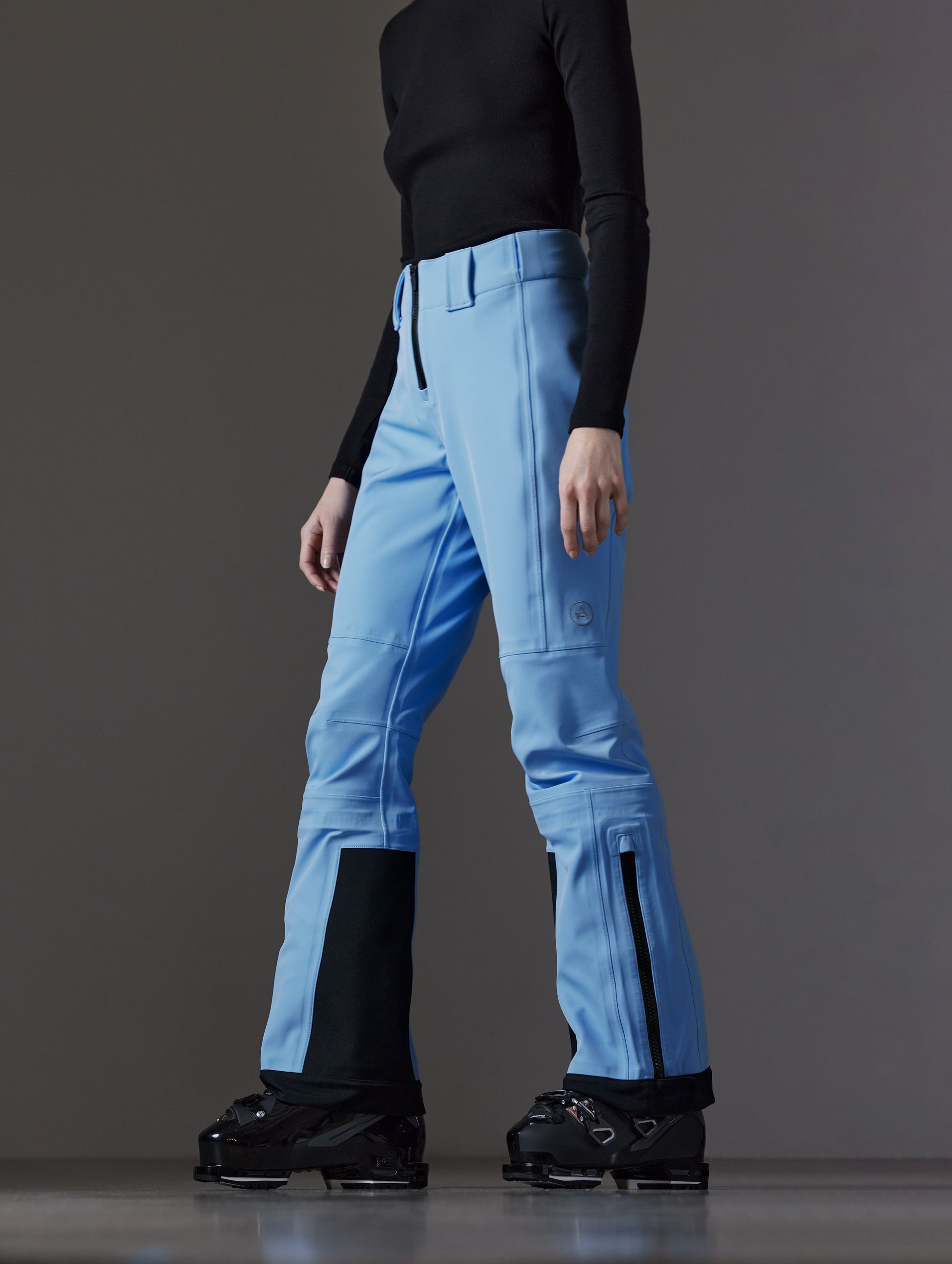Front angled lower body view of woman wearing Descent Pant in Atlas Blue from AETHER Apparel.