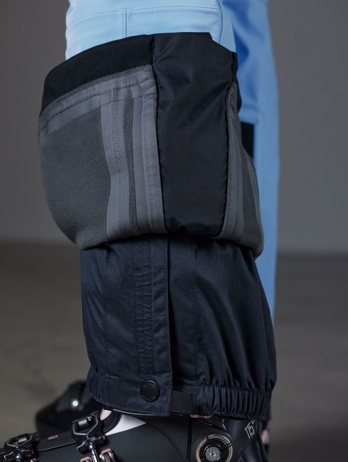 Closeup detailed view of the interior snow gaiters at the leg opening of the Descent Pant in Atlas Blue from AETHER Apparel.
