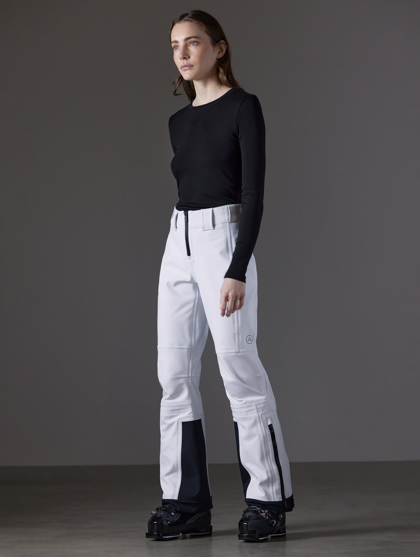 Front angled full-body view of woman wearing Descent Pant in White from AETHER Apparel.