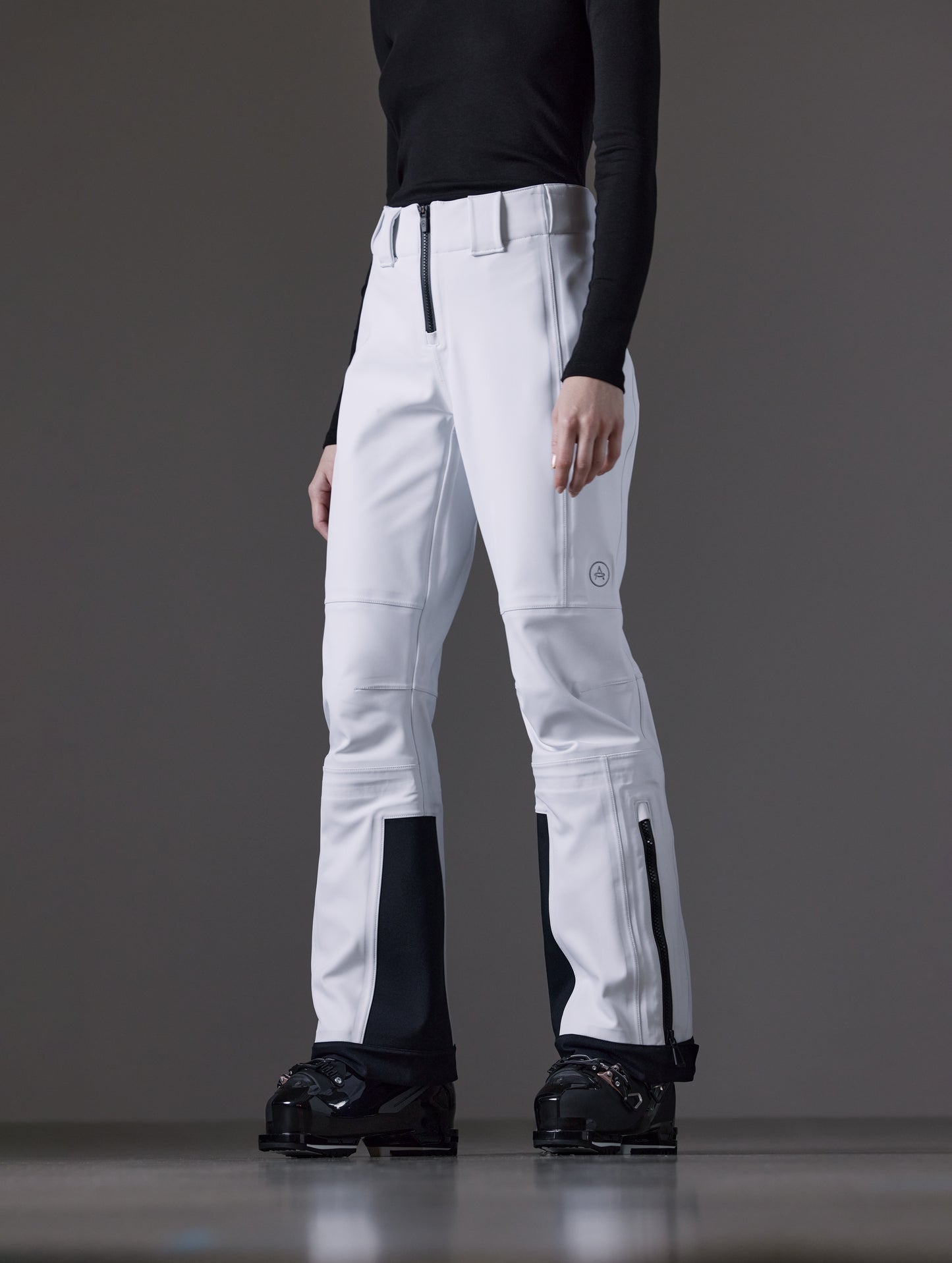Front angled lower body view of woman wearing Descent Pant in White from AETHER Apparel.