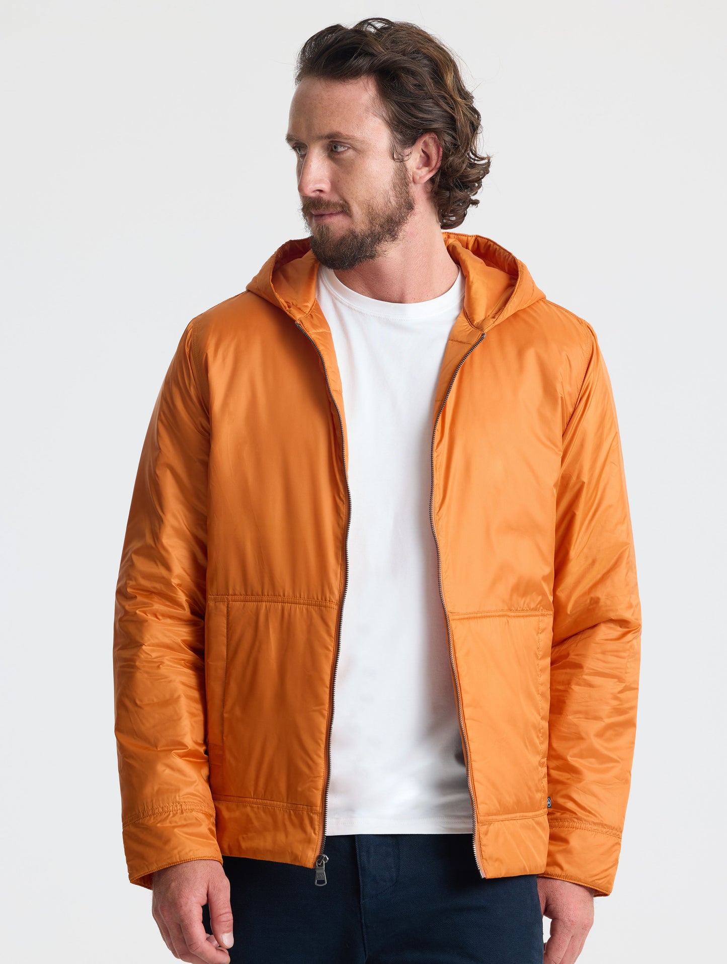 Front view of man wearing unzipped Eco Space Hoodie in Autumn Orange from AETHER Apparel.