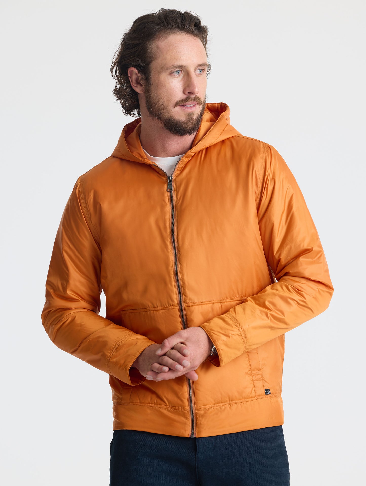 Front view of man wearing zipped Eco Space Hoodie in Autumn Orange from AETHER Apparel.