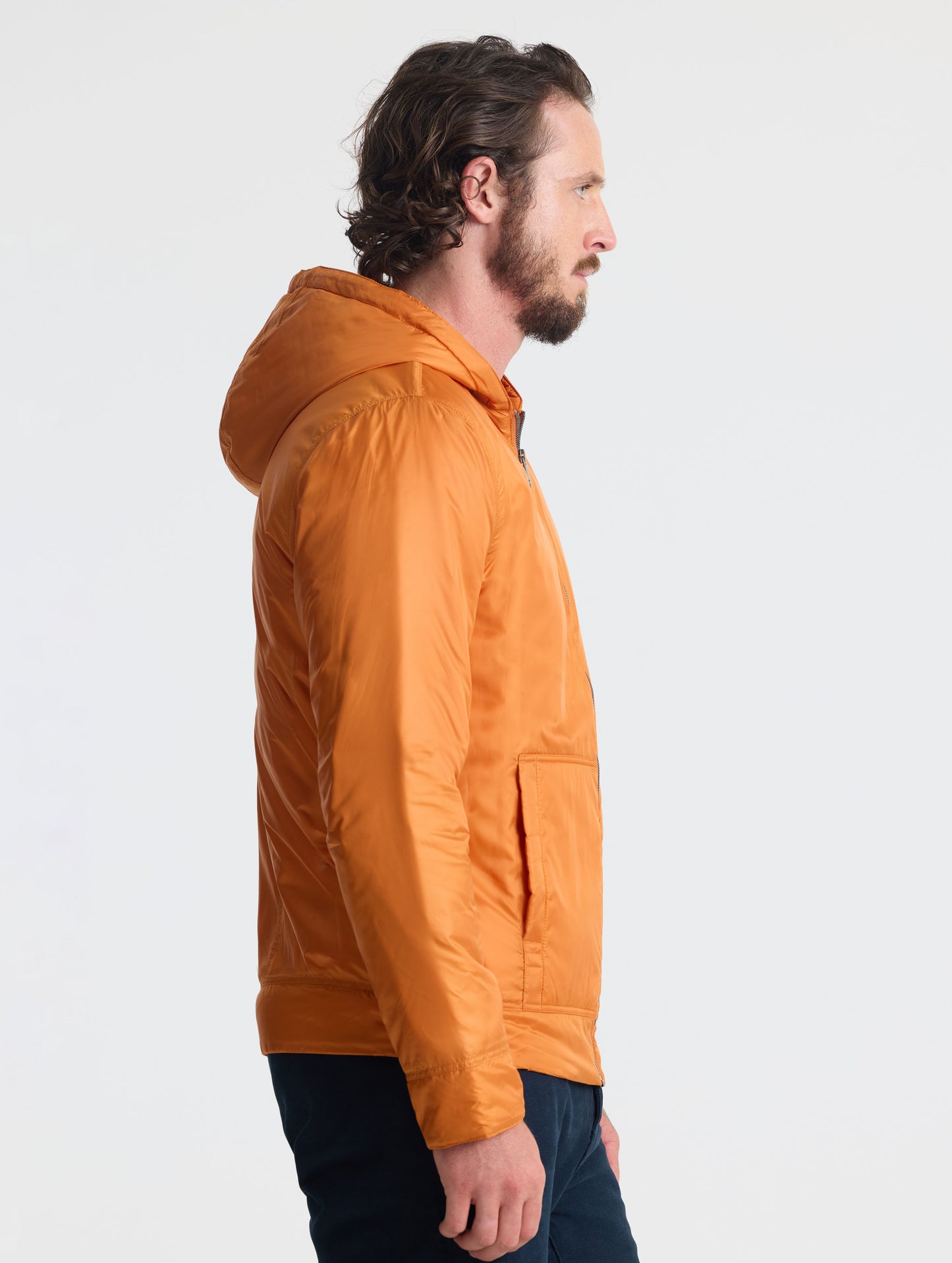 Right profile view of man wearing Eco Space Hoodie in Autumn Orange from AETHER Apparel.