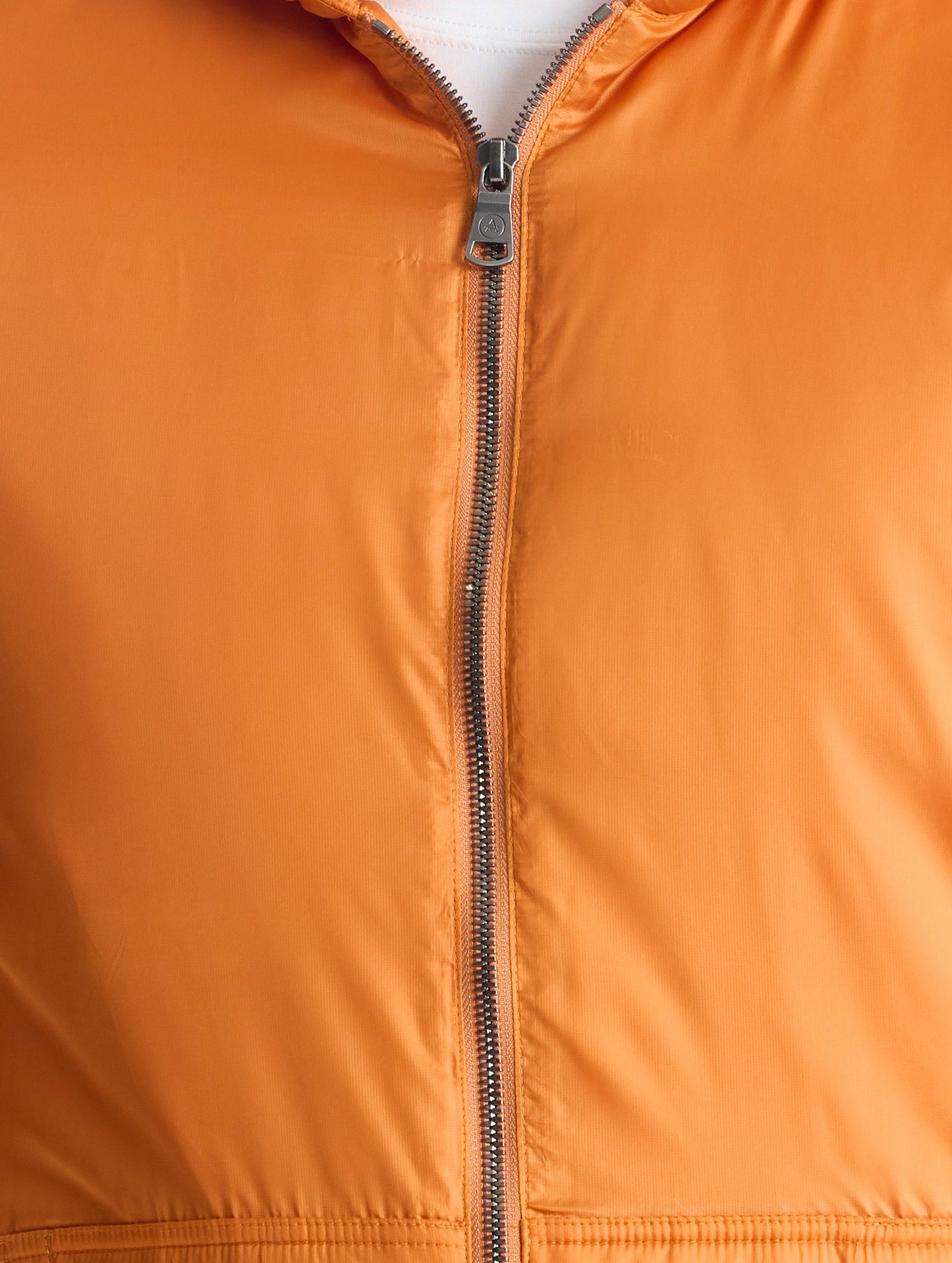 Closeup view of center zipper of Eco Space Hoodie in Autumn Orange from AETHER Apparel.