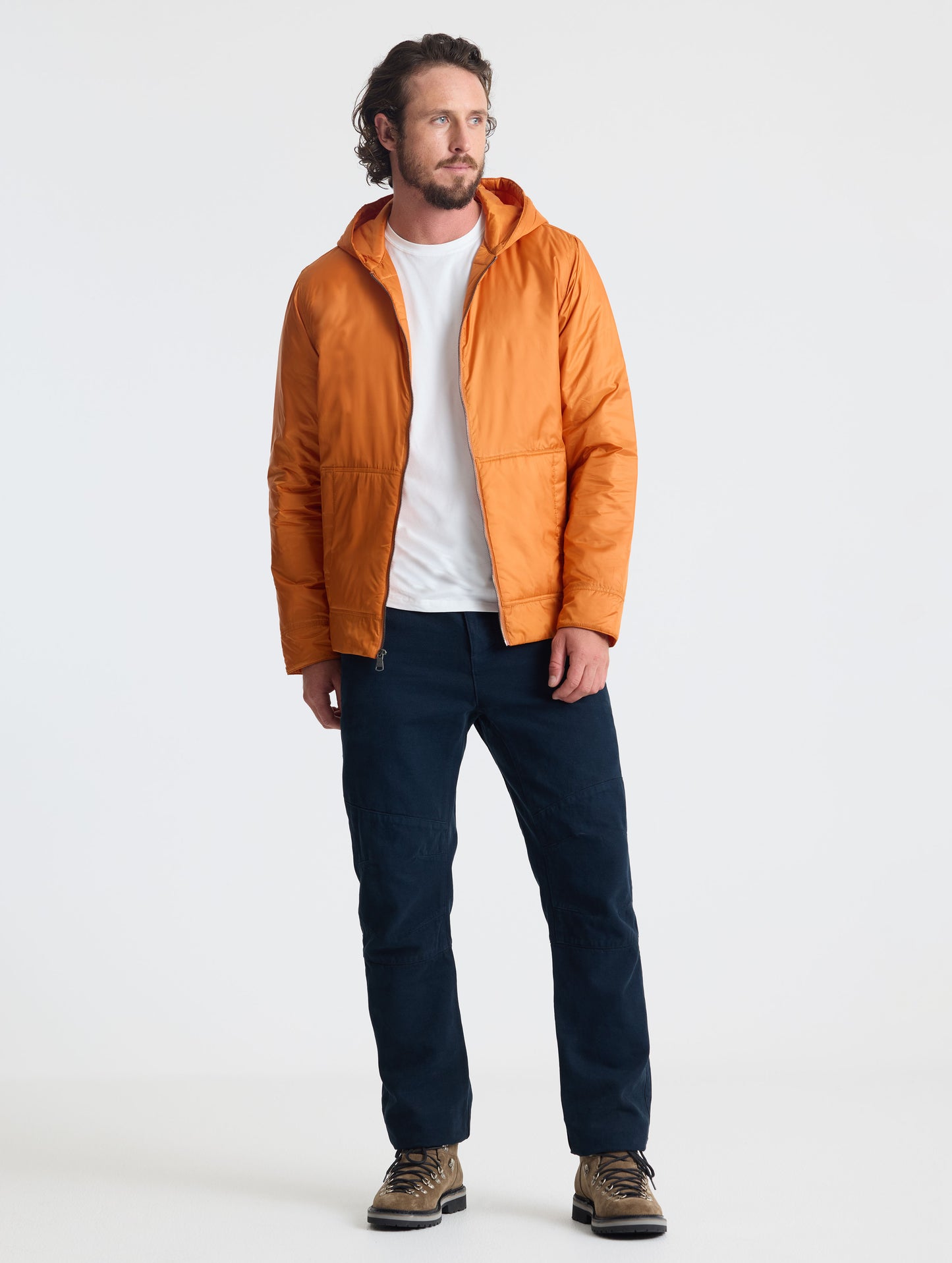 Full body view of man wearing Eco Space Hoodie in Autumn Orange from AETHER Apparel.