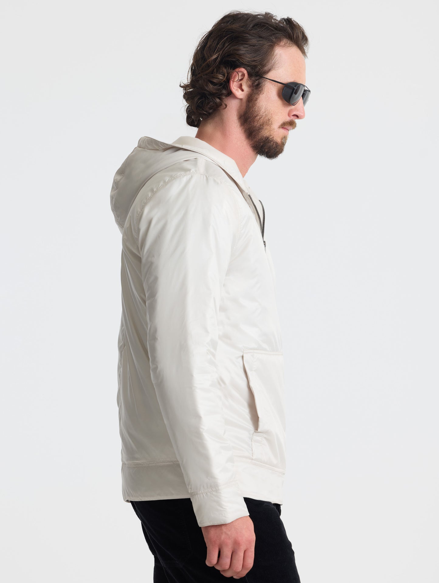 Right profile view of man wearing Eco Space Hoodie in Bone white from AETHER Apparel.