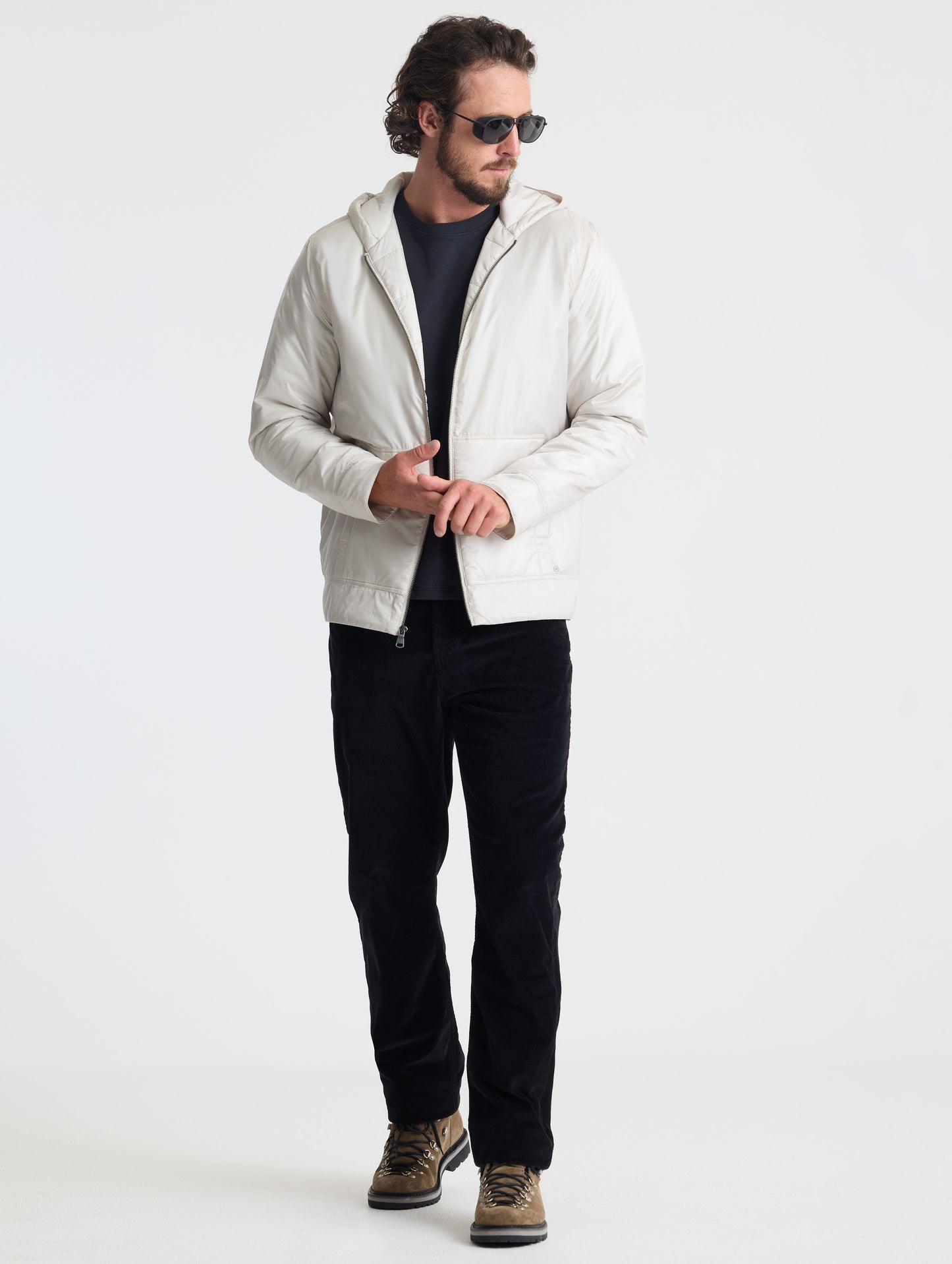 Full body view of man wearing Eco Space Hoodie in Bone white from AETHER Apparel.