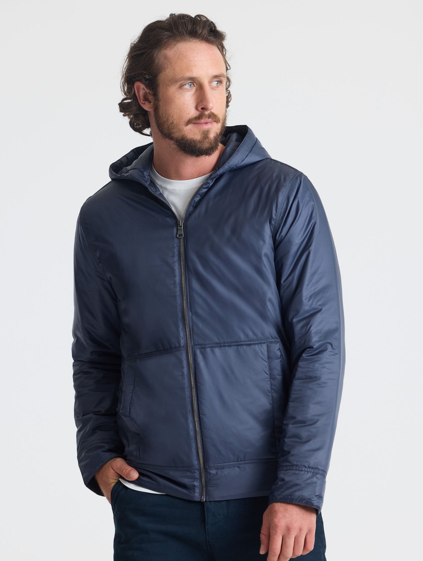 Front view of man wearing unzipped Eco Space Hoodie in Total Eclipse dark blue from AETHER Apparel.
